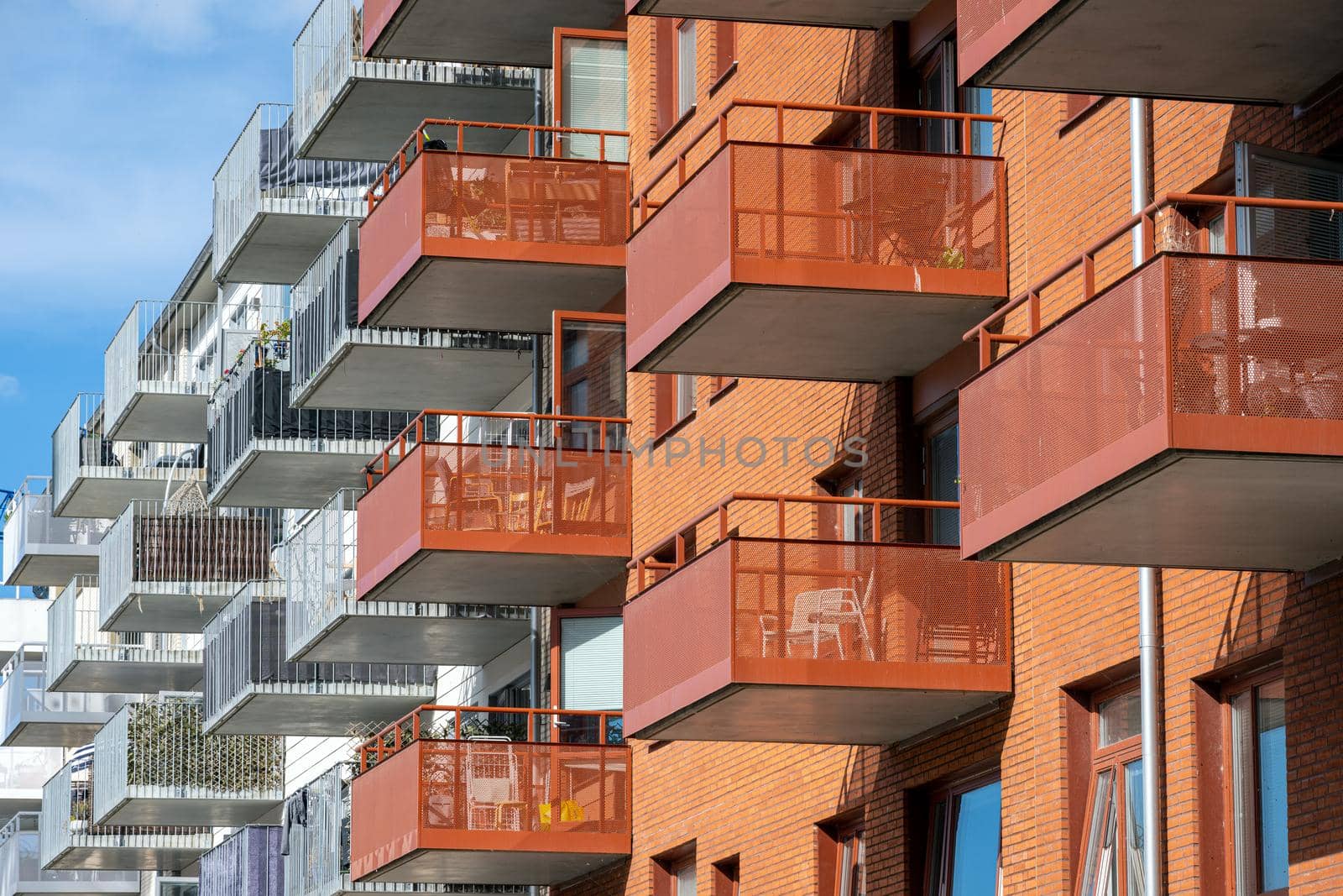 Detail of red and white apartment buildings with many balconies seen in Berlin, Germany