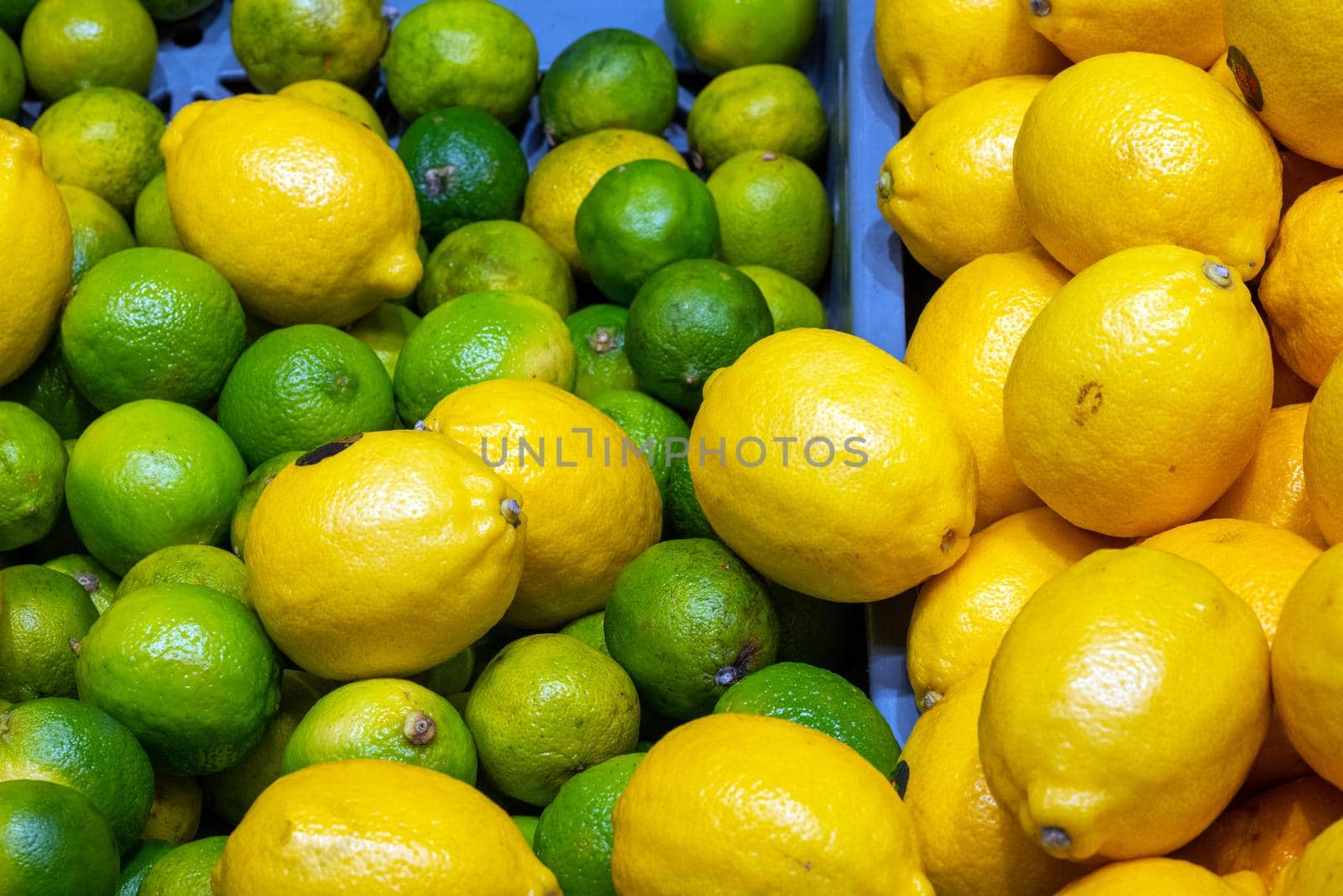 Green limes and yellow lemons for sale at a market