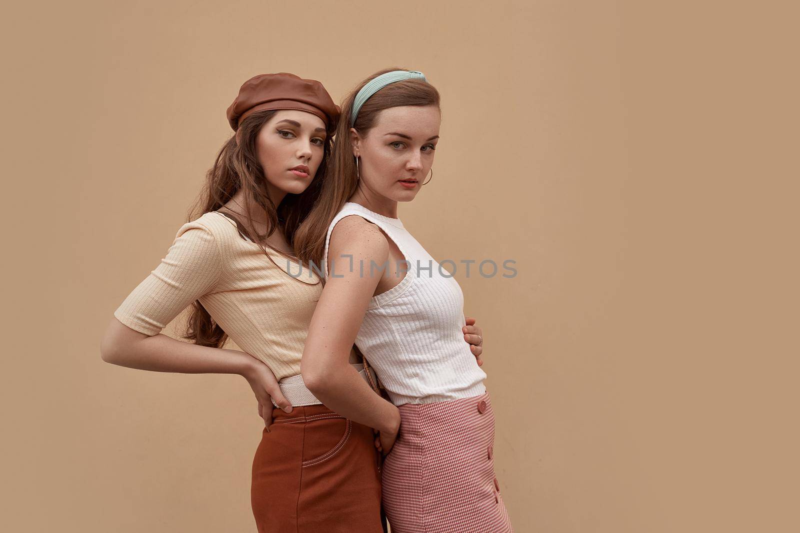 Young beautiful girls dressed in retro vintage style enjoying the old european city summertime lifestyle