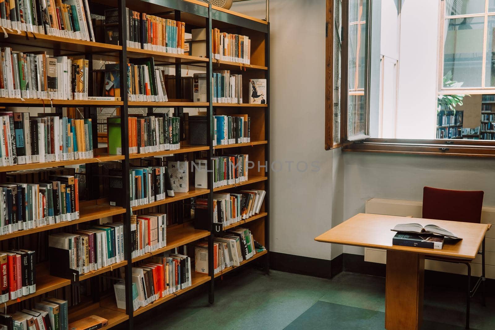 Prague, Czech Republic - July, 2022. Public Municipal Library with colorful paper books on shelves. Education, science, literature concept. High quality photo