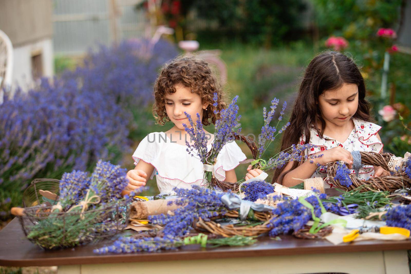 Girls make homemade lavender wreaths as a decor for home or present