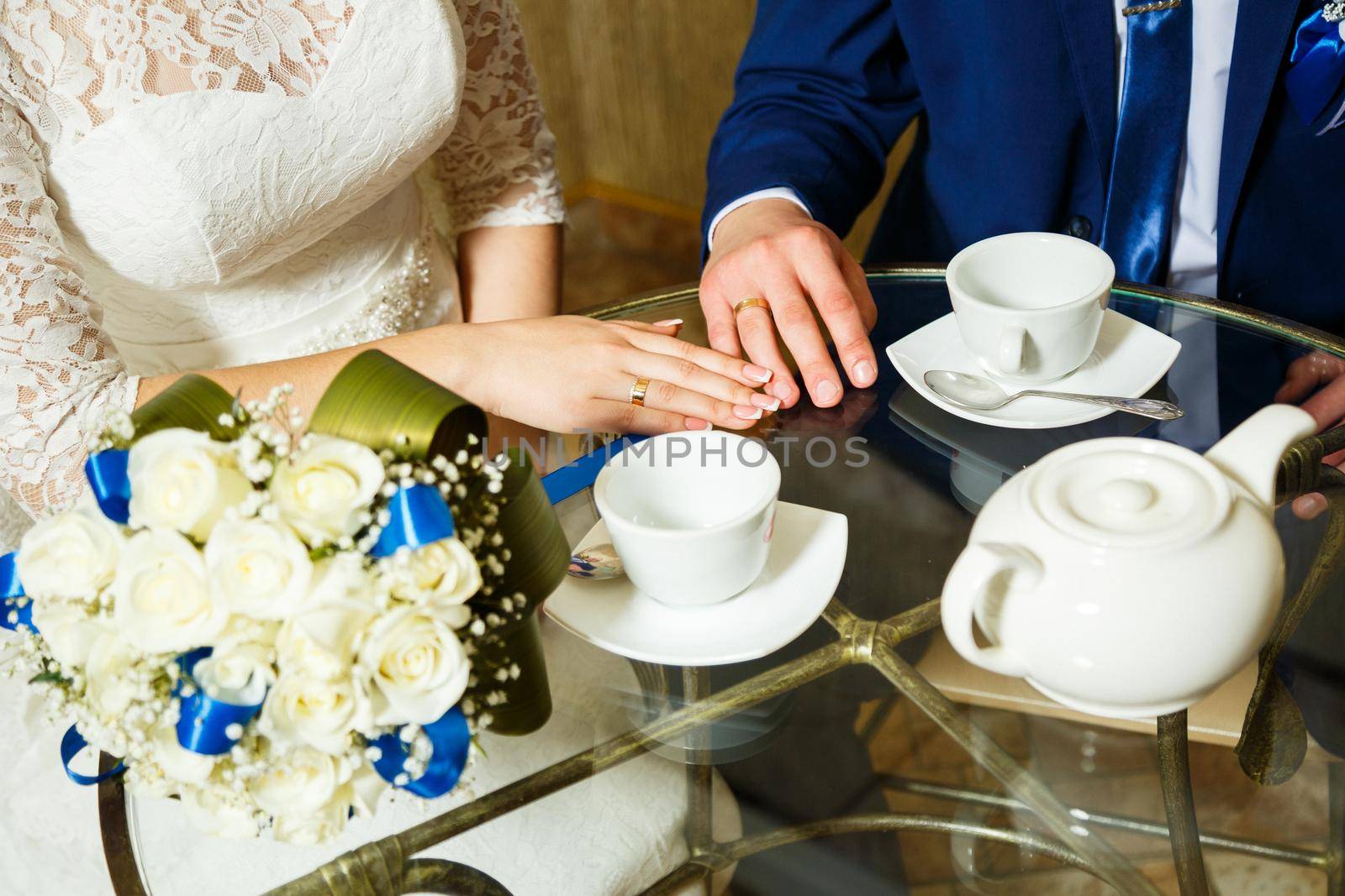 Groom and bride in a cafe with a cup of coffee