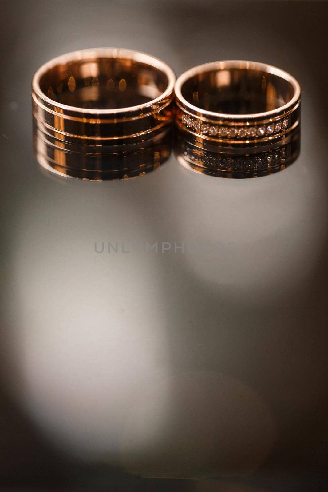 Gold wedding rings for newlyweds on their wedding day. Jewelry for the holiday of a couple in love