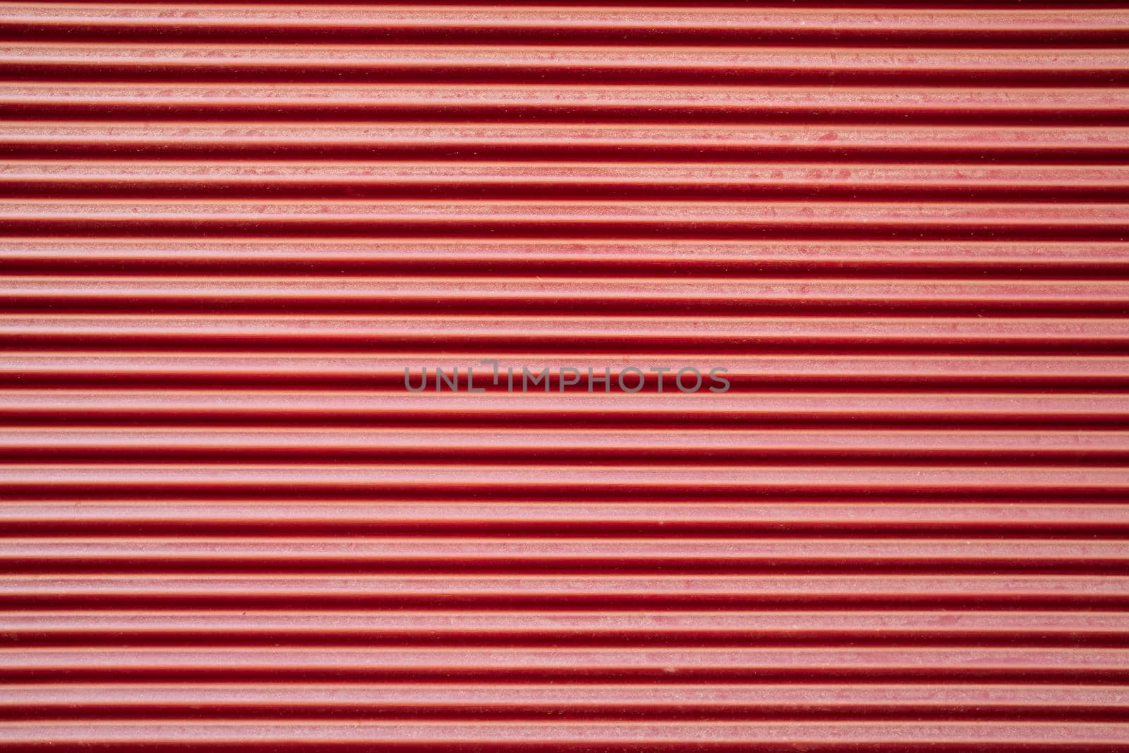 Parallel red vertical lines background. Metallic texture, natural abstract stripes. Perfect for mock-up and design. Seamless pattern. High quality photo