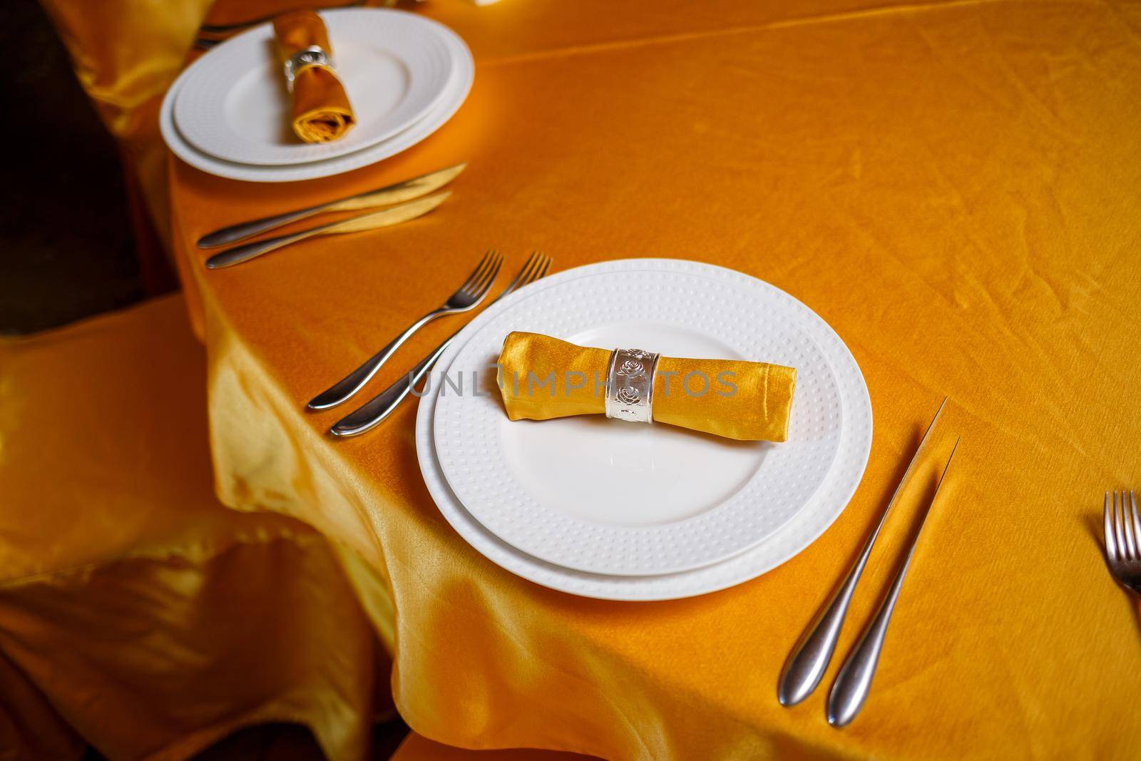 Elegant table setting with fork, knife and gold napkin