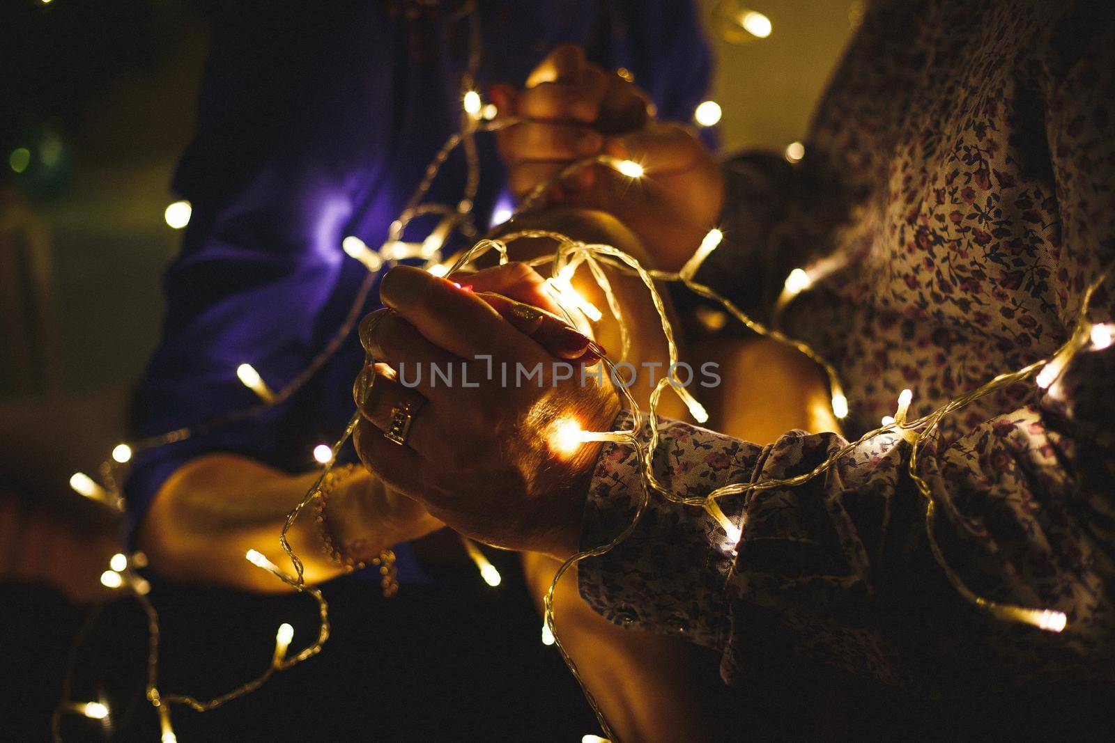 Yellow luminous garland in the hands