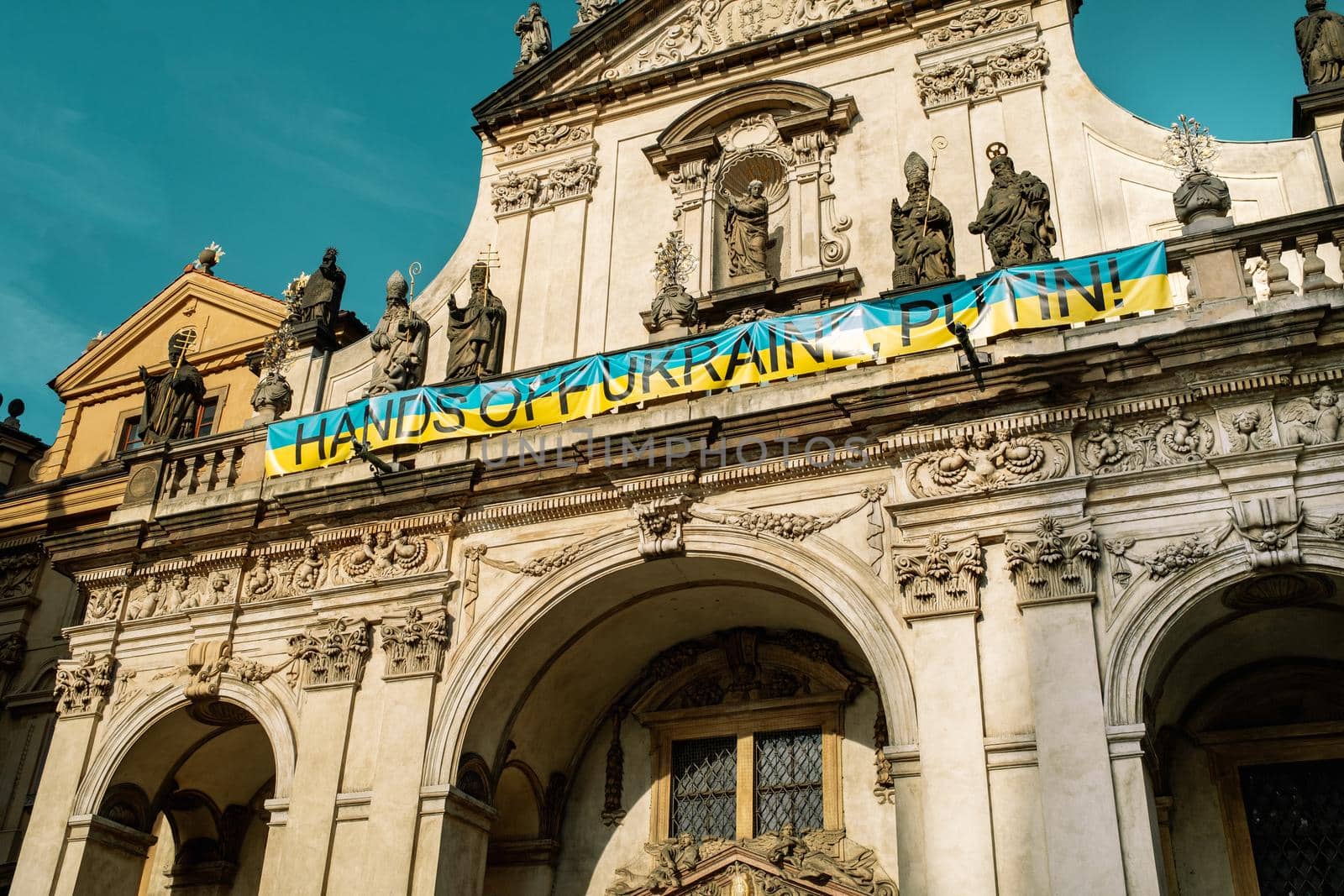 Church of St. Salvator with hands off Ukraine putin sign on facade in support. Historic complex Clementinum. Baroque details architecture. High quality photo