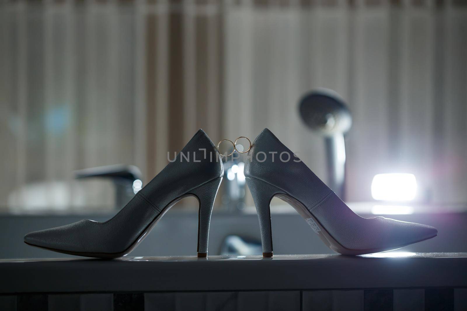 Bride's engagement ring on wedding day with beautiful holiday shoes by Dmitrytph