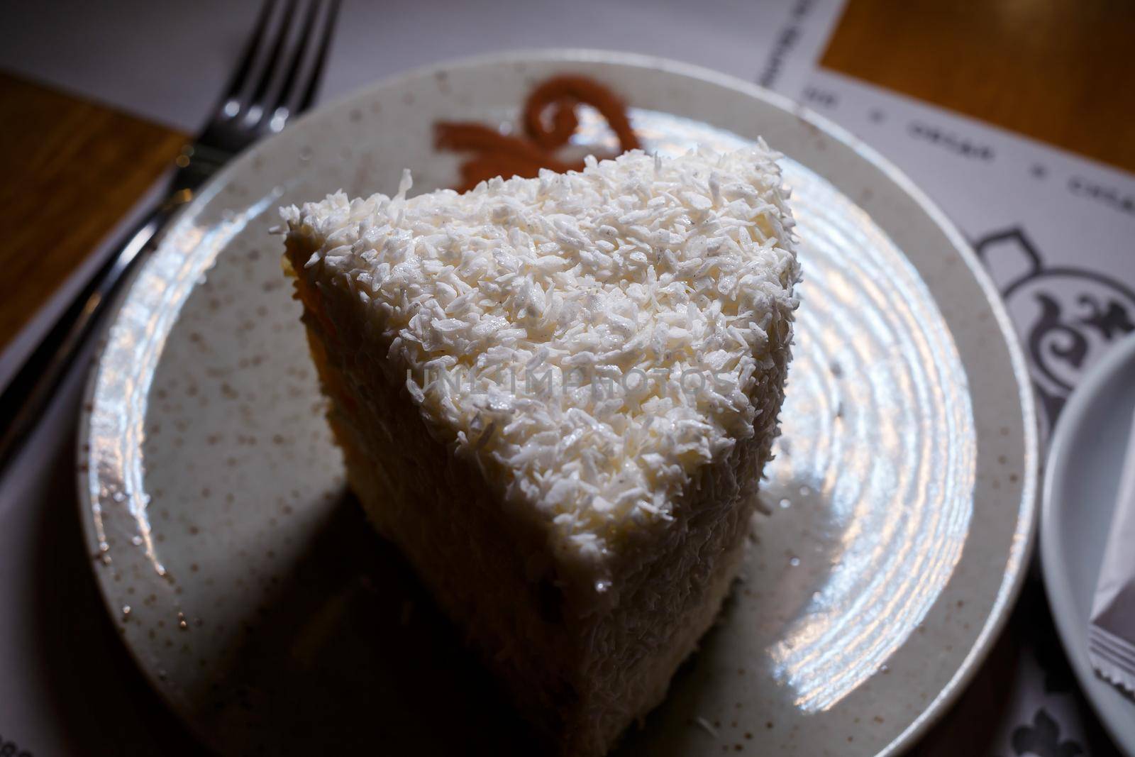 Delicious sweet piece of coconut cake with biscuit cakes