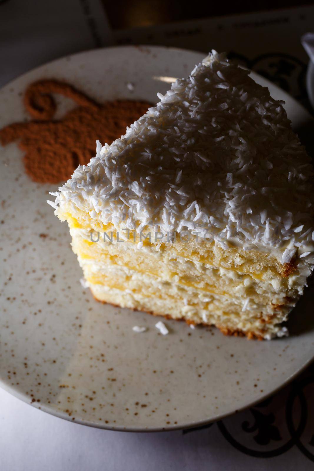 Delicious sweet piece of coconut cake with biscuit cakes