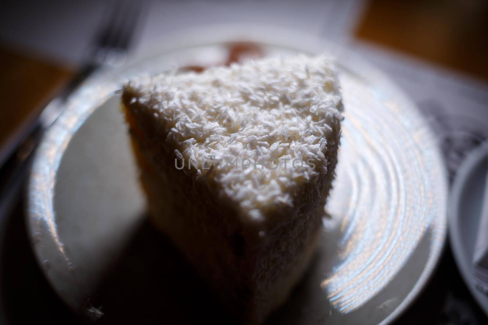 Delicious sweet piece of coconut cake with biscuit cakes