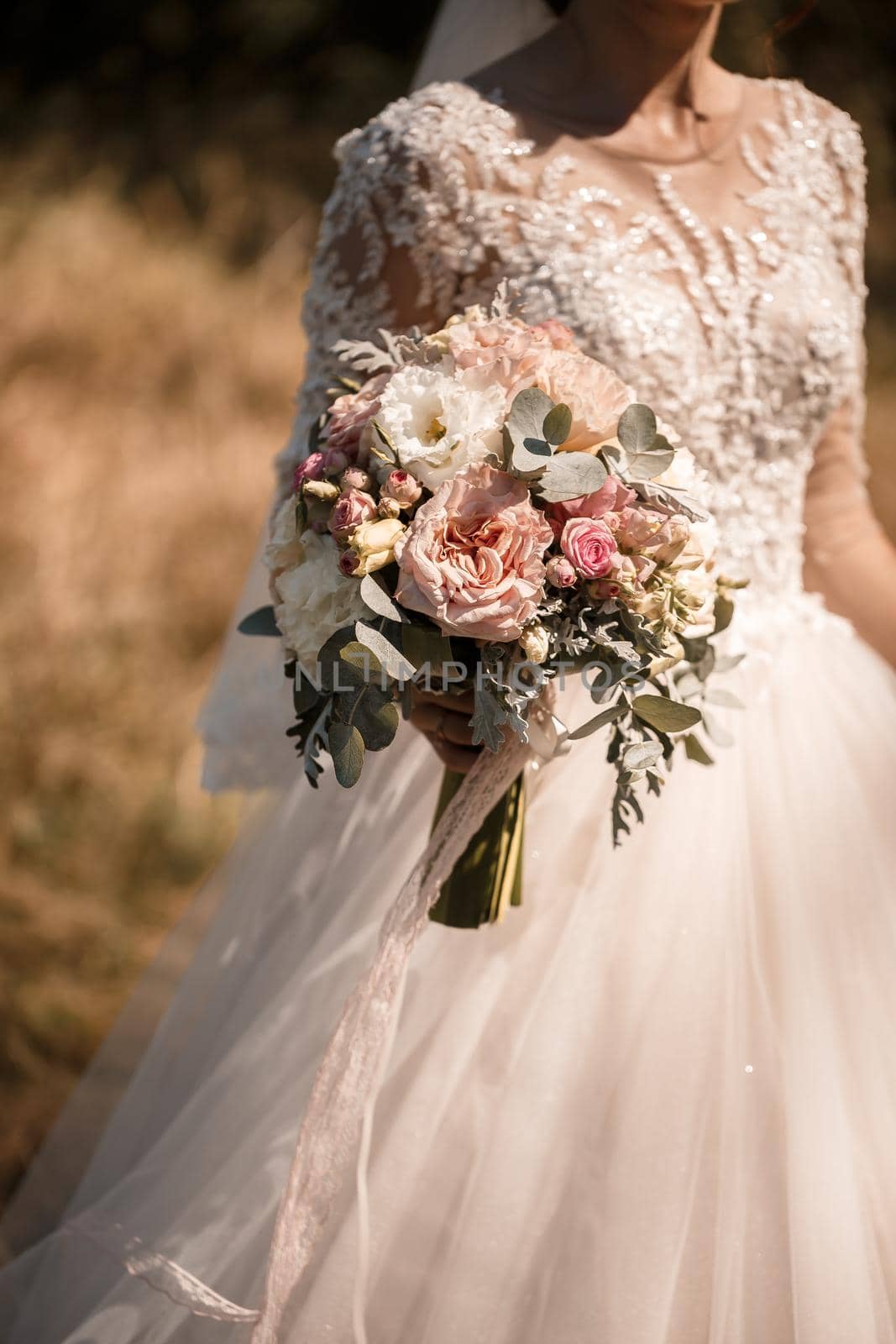 A bouquet of fresh flowers in the hands of the bride by Dmitrytph