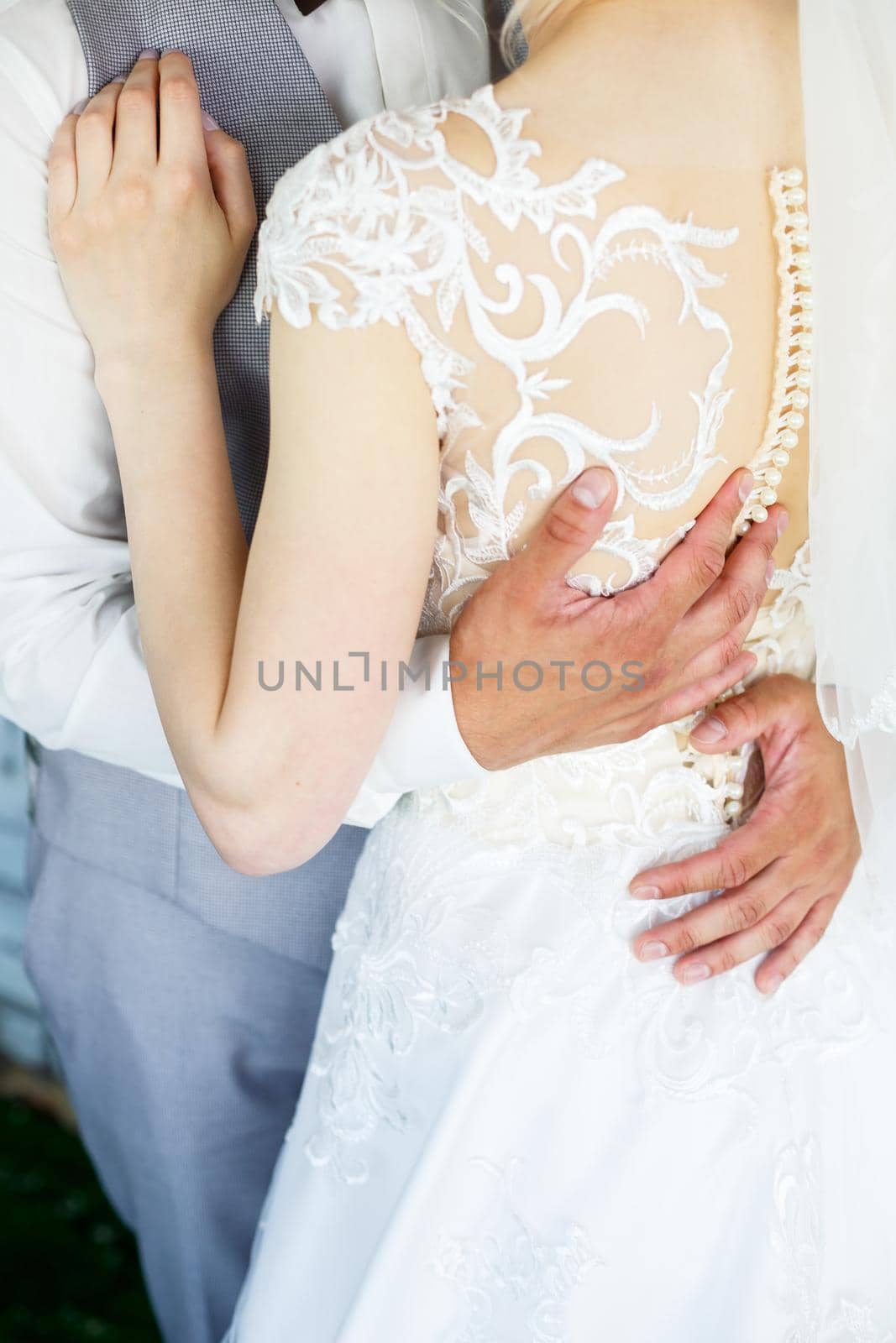 Bride and groom hugging on a wedding day by Dmitrytph