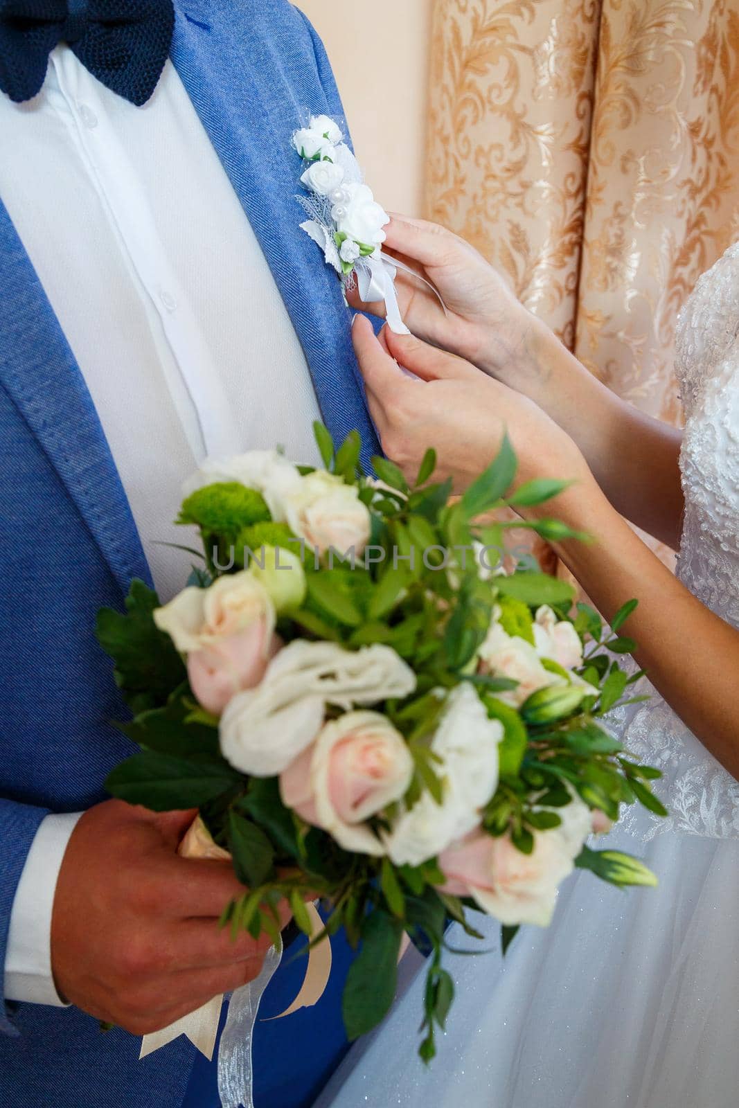 Beautiful wedding bouquet of flowers in the hands of the newlyweds by Dmitrytph