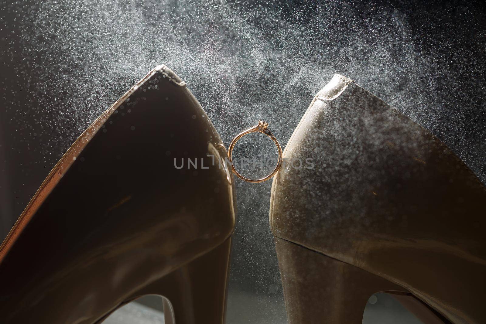 Gold wedding ring with women's shoes on the wedding day