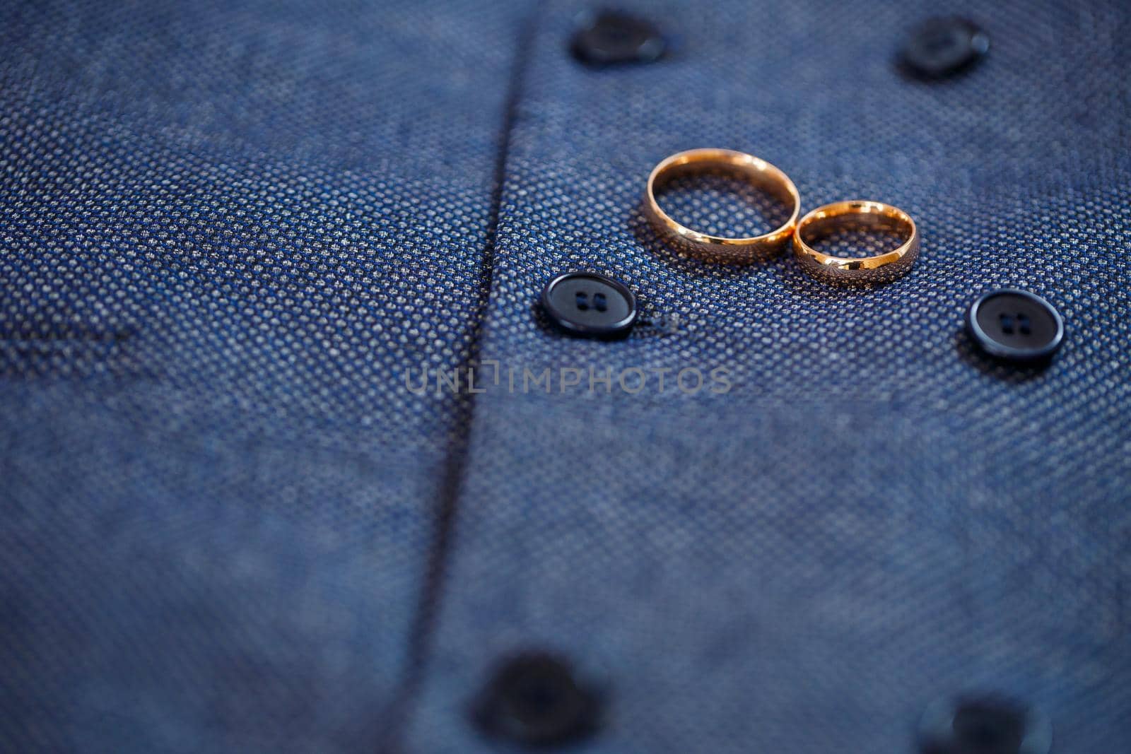 Golden wedding rings for newlyweds on their wedding day by Dmitrytph