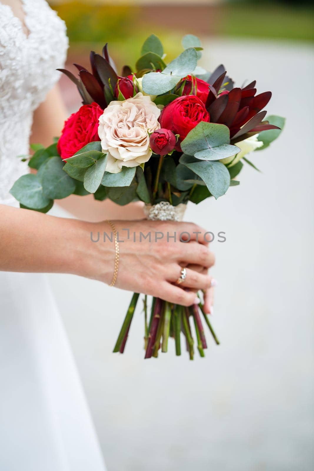 Beautiful wedding bouquet of flowers in the hands of the newlyweds