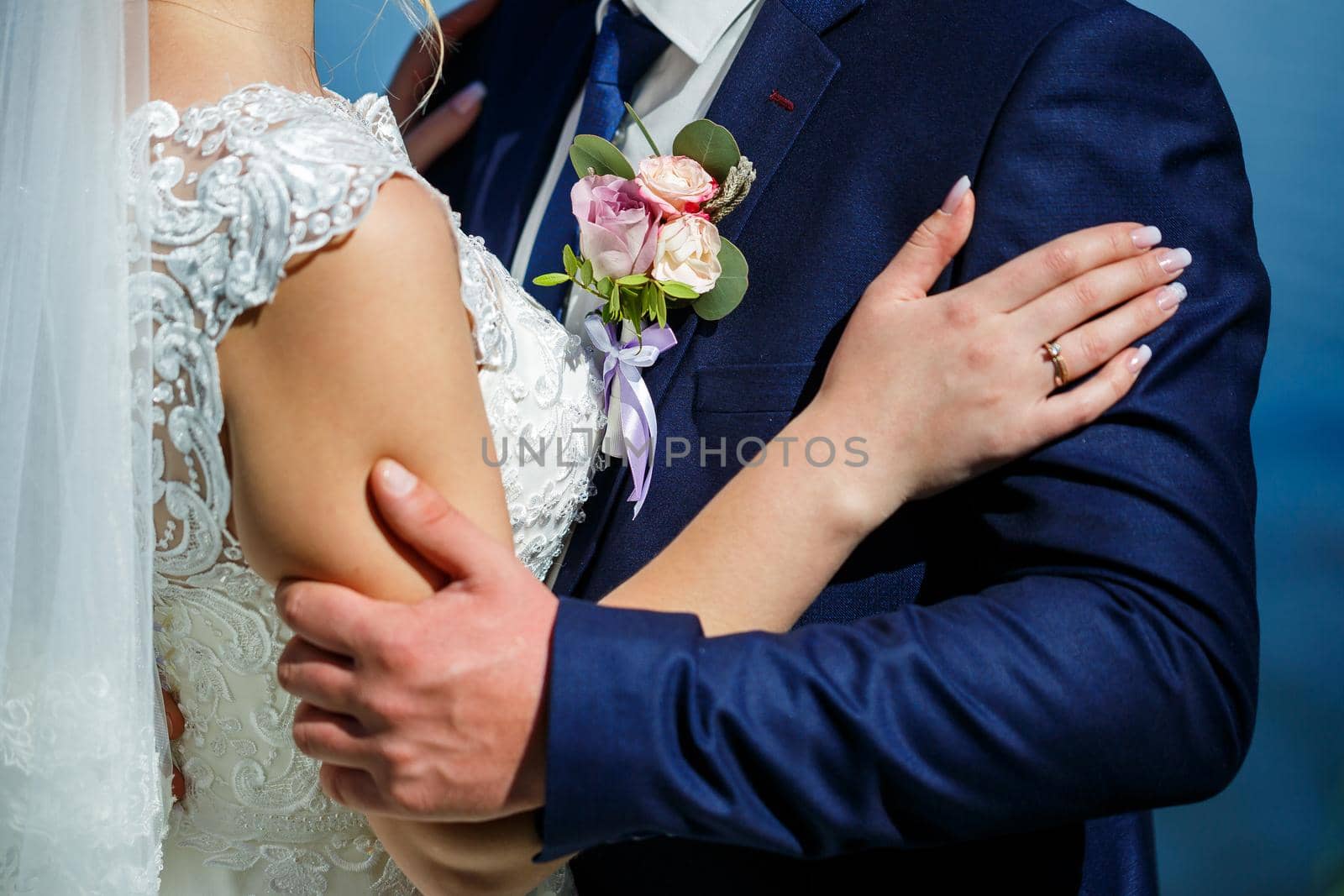 Bride and groom hugging on a wedding day by Dmitrytph
