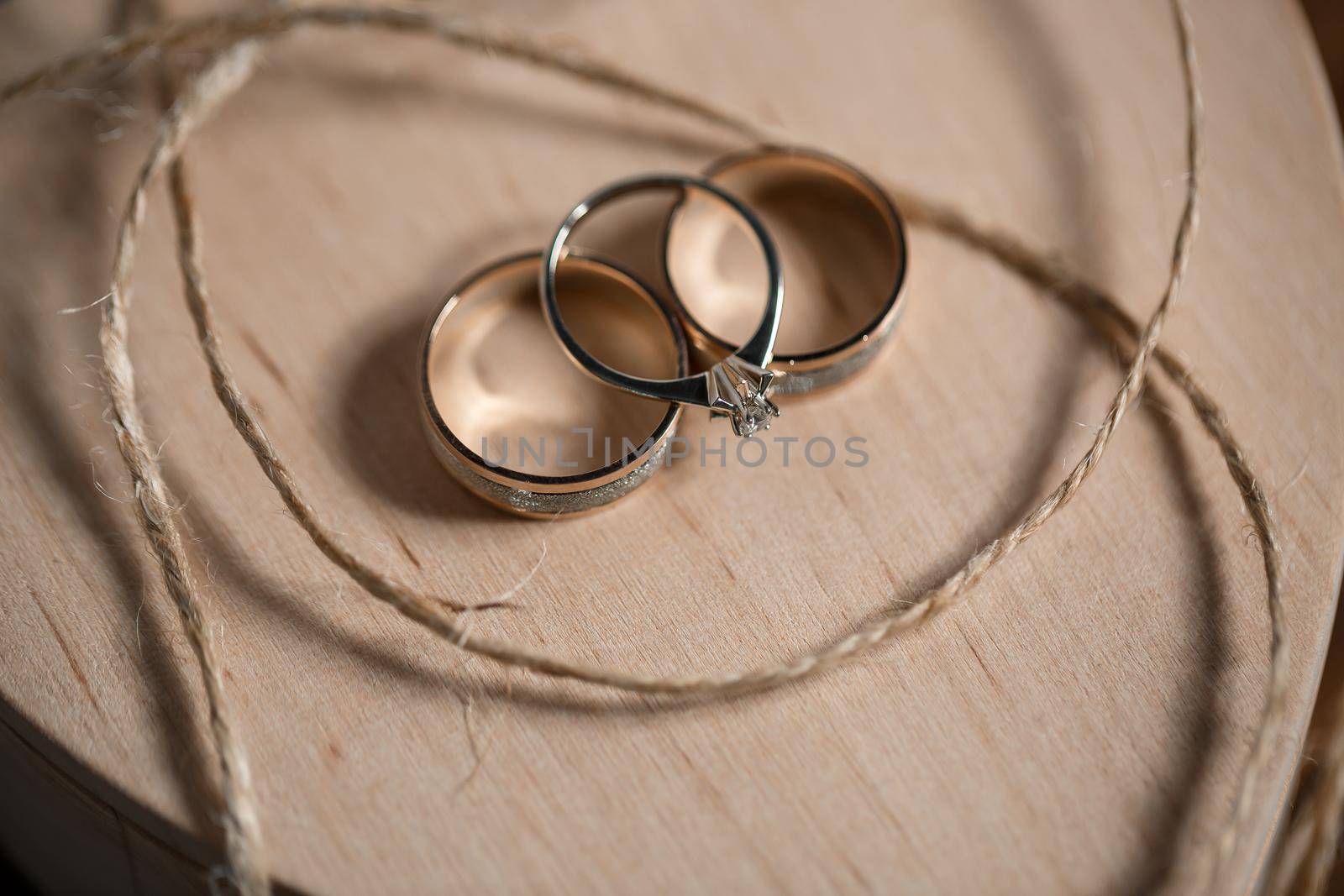 Gold wedding rings for newlyweds on their wedding day. Jewelry for the holiday of a couple in love