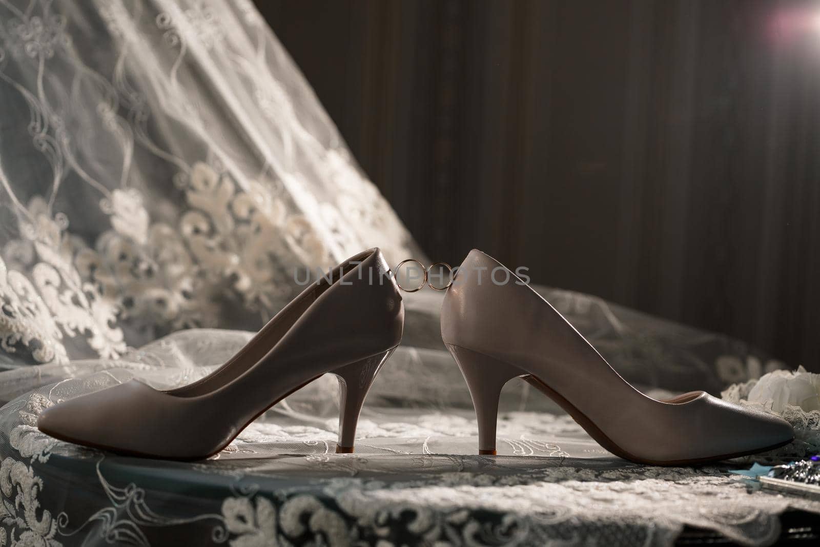 Bride's engagement ring on wedding day with beautiful holiday shoes by Dmitrytph