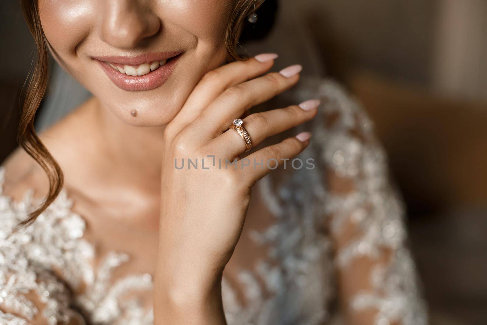 Gentle female hands of the bride with a gold wedding ring on the ring finger