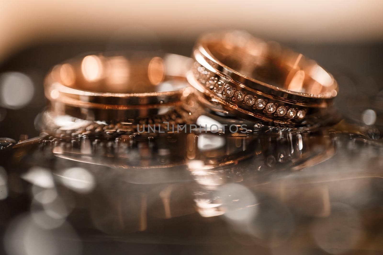 Gold wedding rings for newlyweds on their wedding day. Jewelry for the holiday of a couple in love