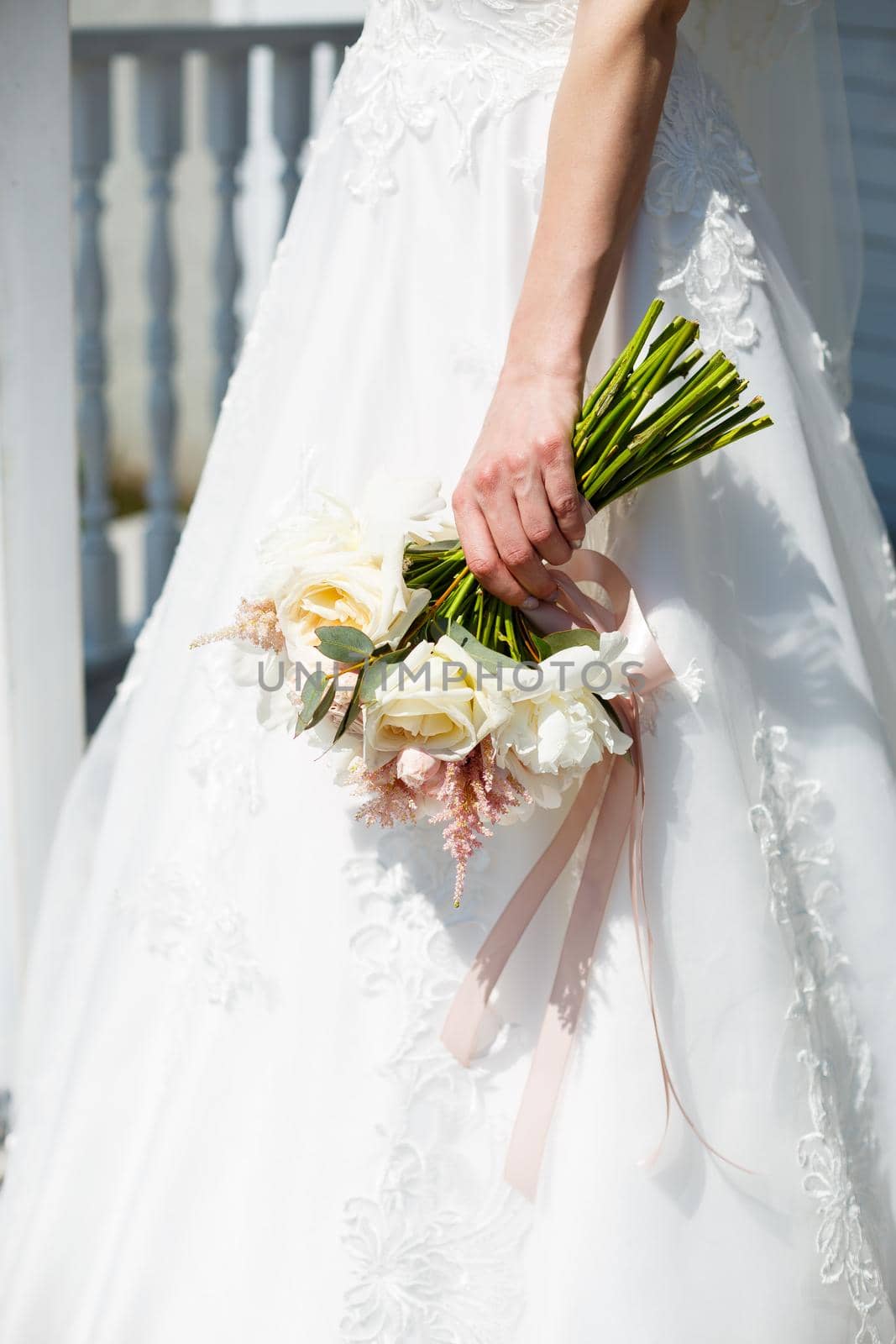 Beautiful wedding bouquet of flowers in the hands of the newlyweds