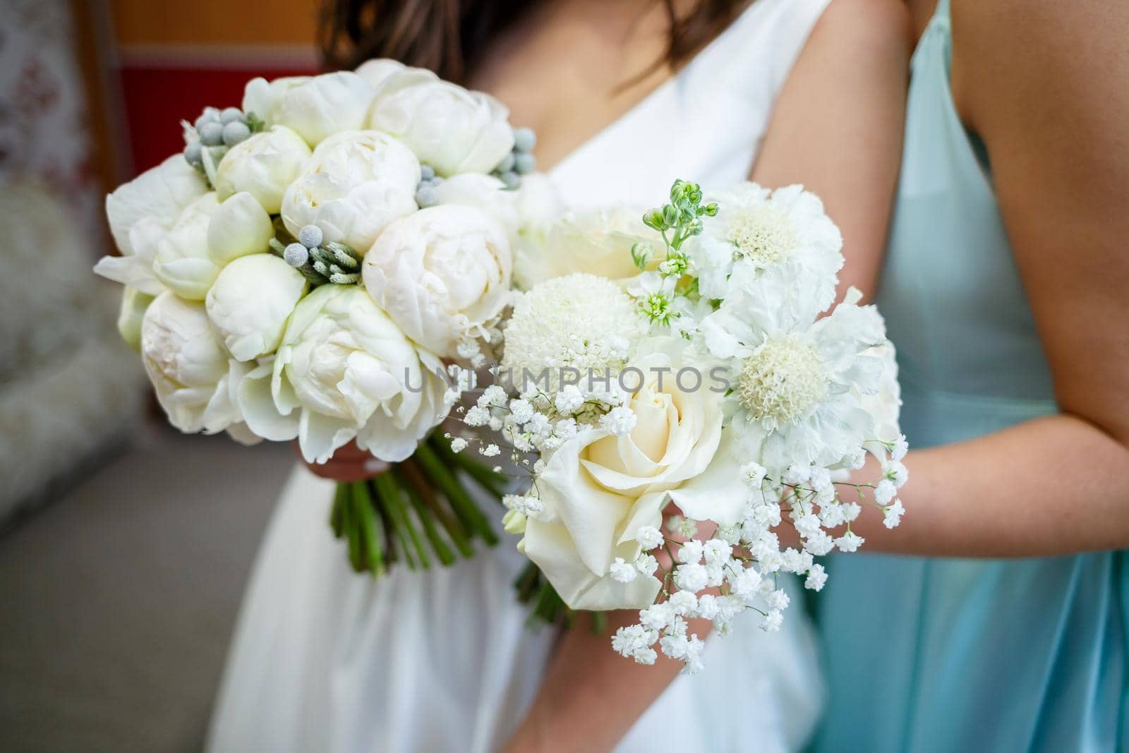 Beautiful wedding bouquet of flowers in the hands of the newlyweds