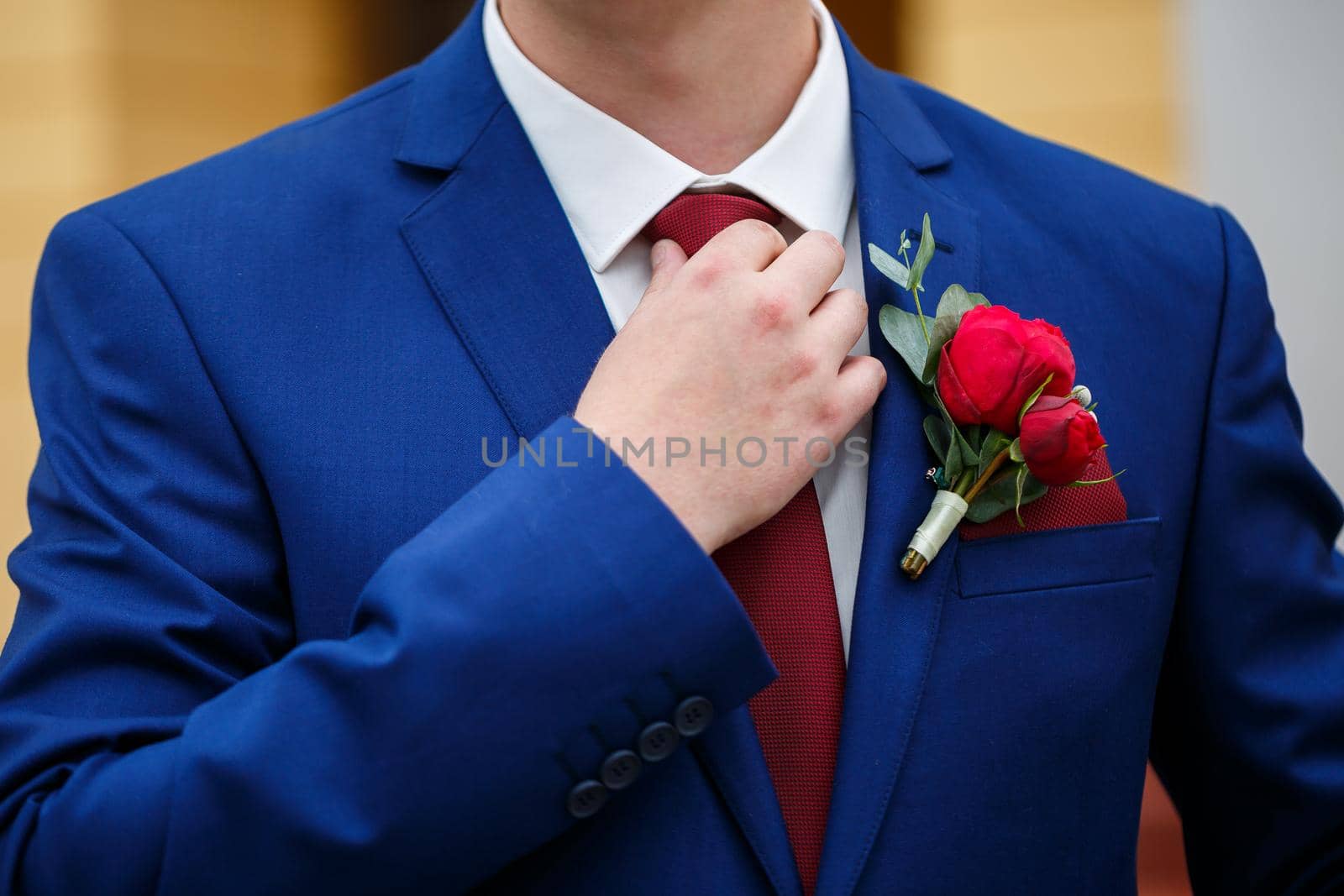 man puts on a suit on the wedding day
