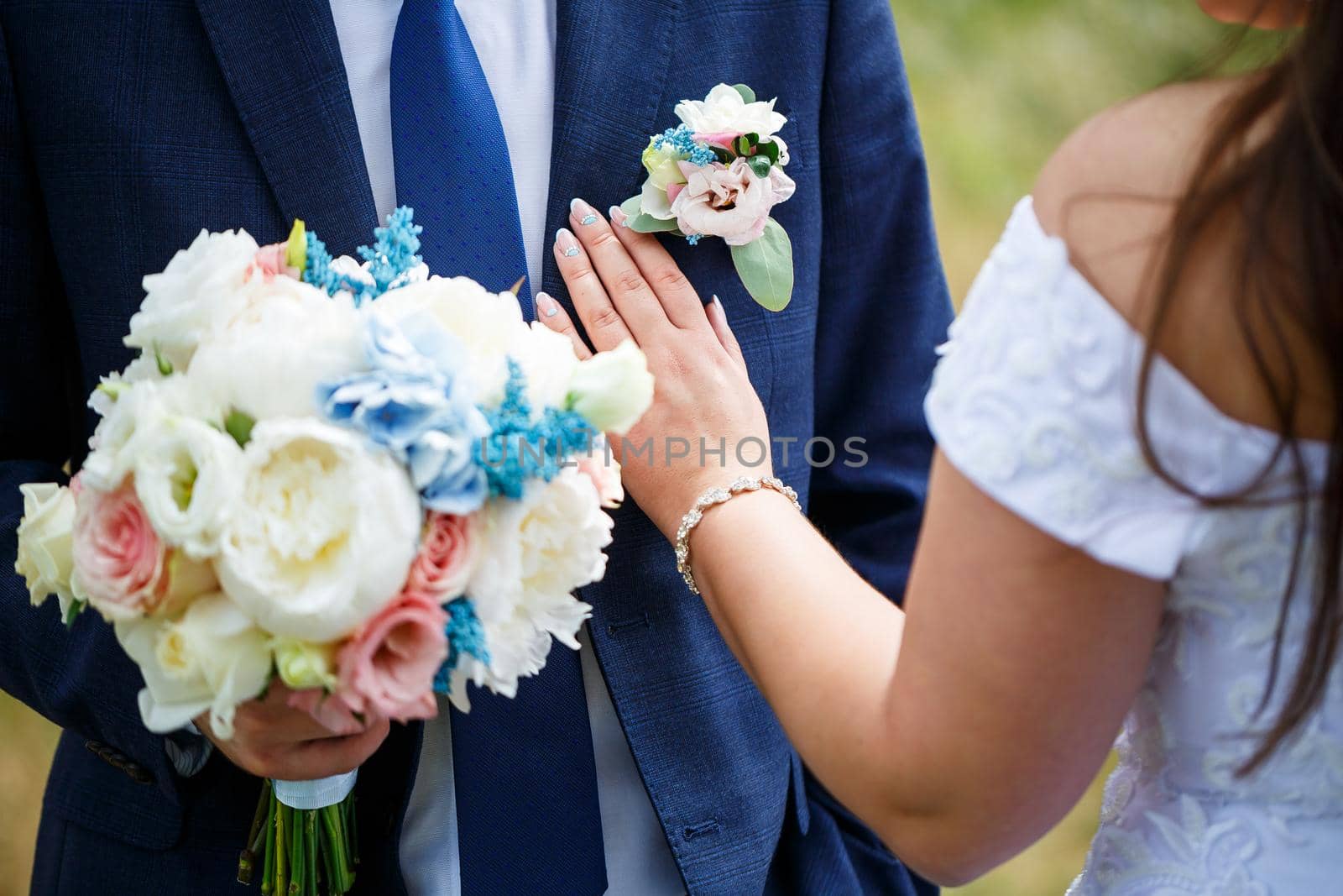 Beautiful wedding bouquet of flowers in the hands of the newlyweds