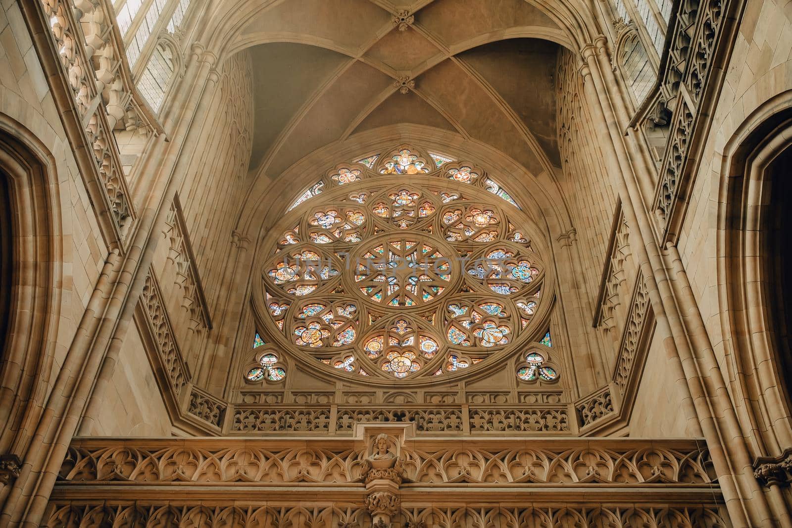 Prague, Czech Republic - July 2022. Central nave in St. Vitus Cathedral. Grand interior, gothic ribbed mesh vaults and rose inside. High ceiling, most famous church in Castle. High quality photo