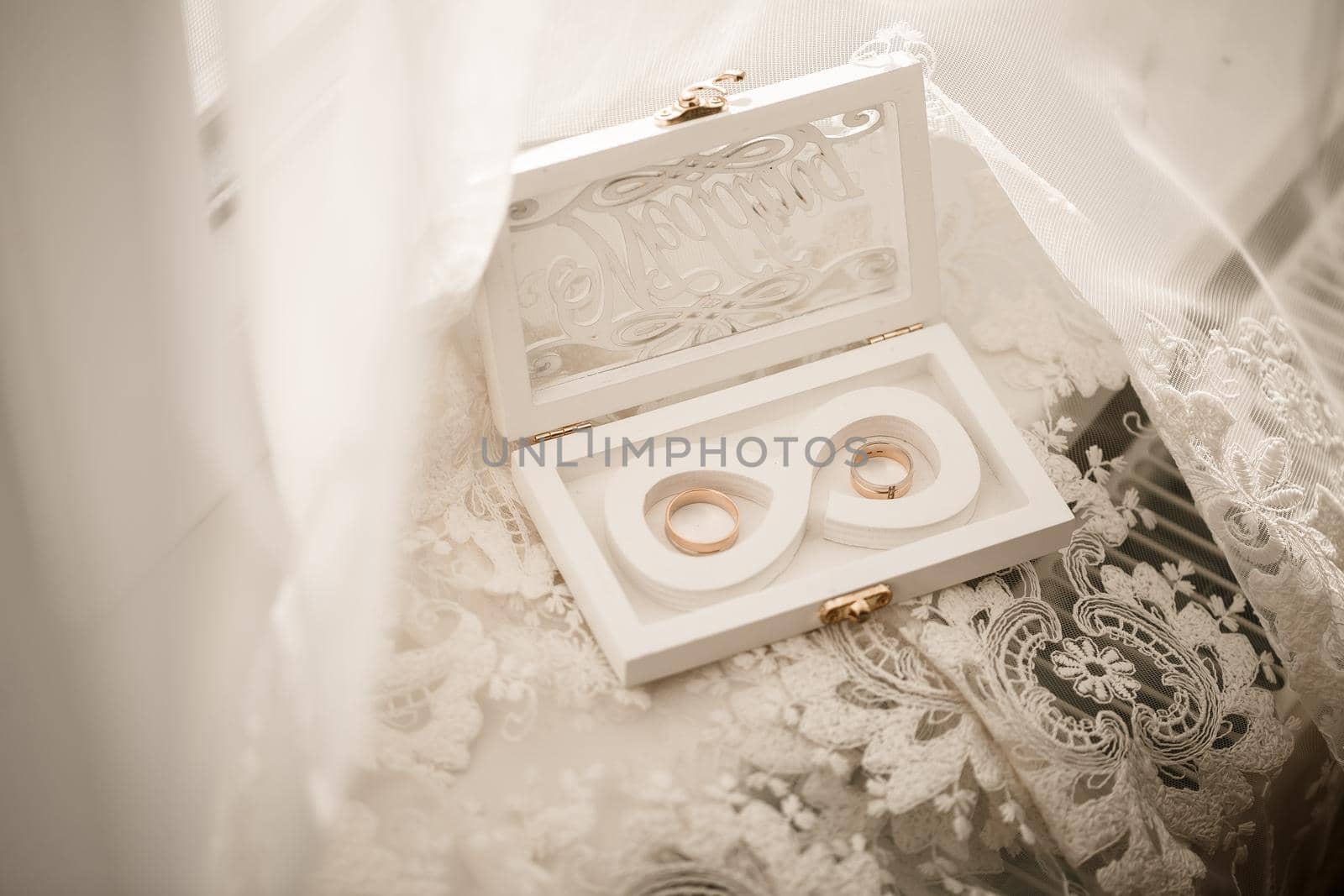 Gold wedding rings for newlyweds on their wedding day. Jewelry for the holiday of a couple in love by Dmitrytph