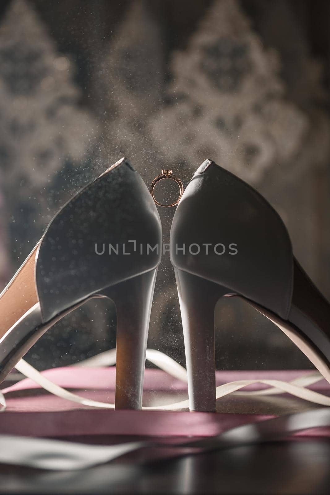 Bride's engagement ring on wedding day with beautiful holiday shoes by Dmitrytph