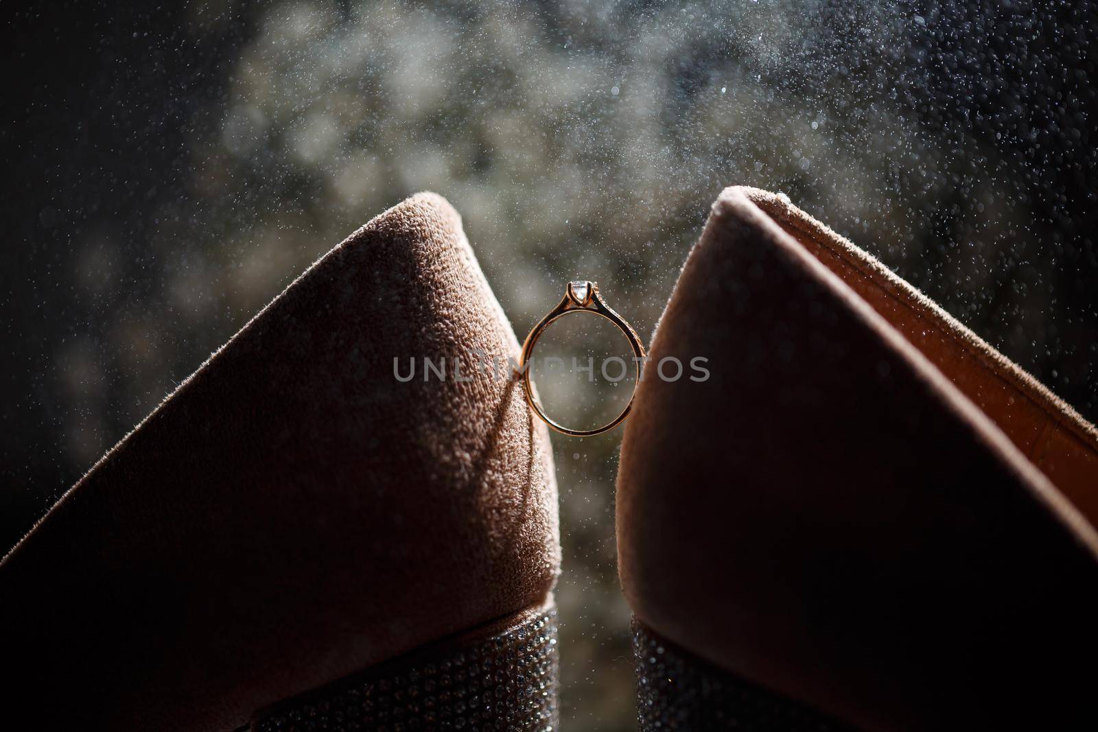 Bride's engagement ring on wedding day with beautiful holiday shoes by Dmitrytph