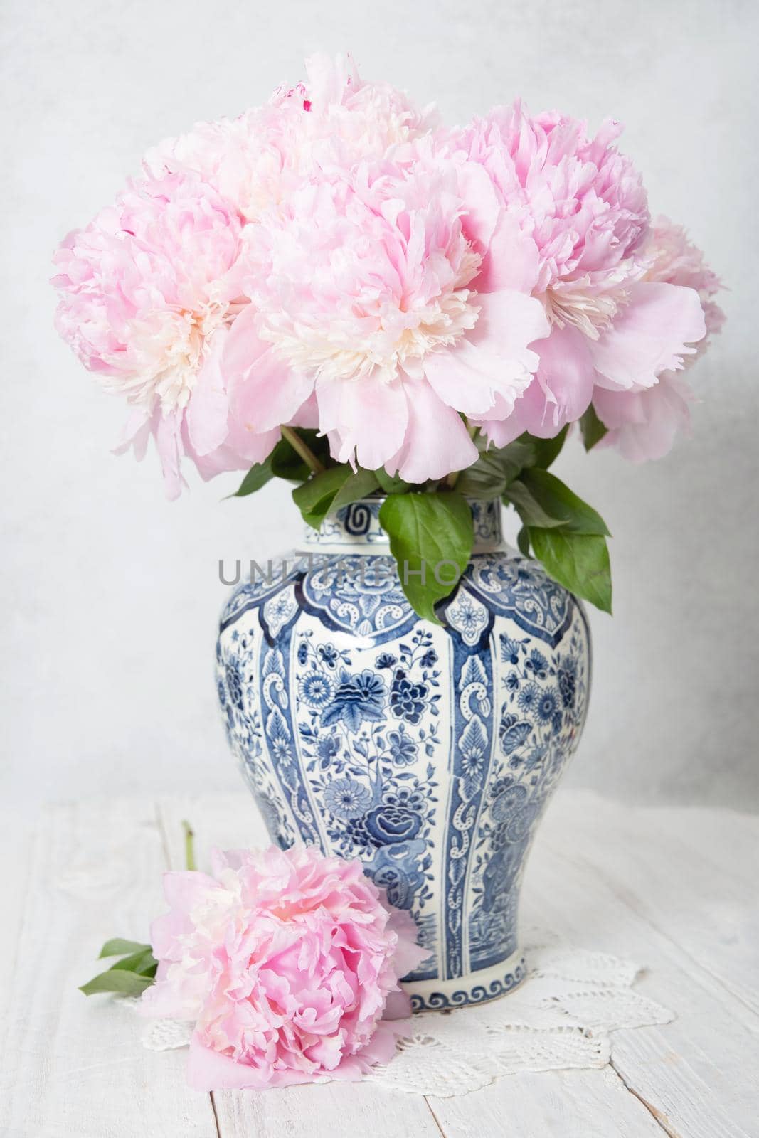 spring still life with bouquet of pink luxurious peonies in an ancient Chinese vase with blue ornament, High quality photo