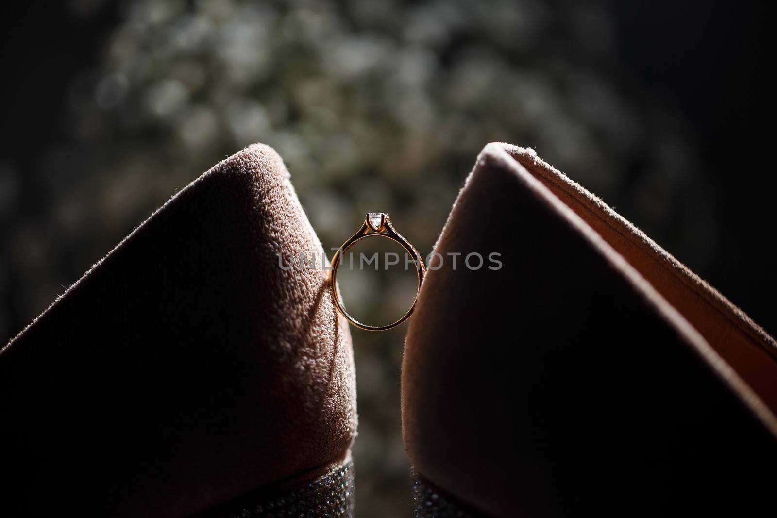 Bride's engagement ring on wedding day with beautiful holiday shoes