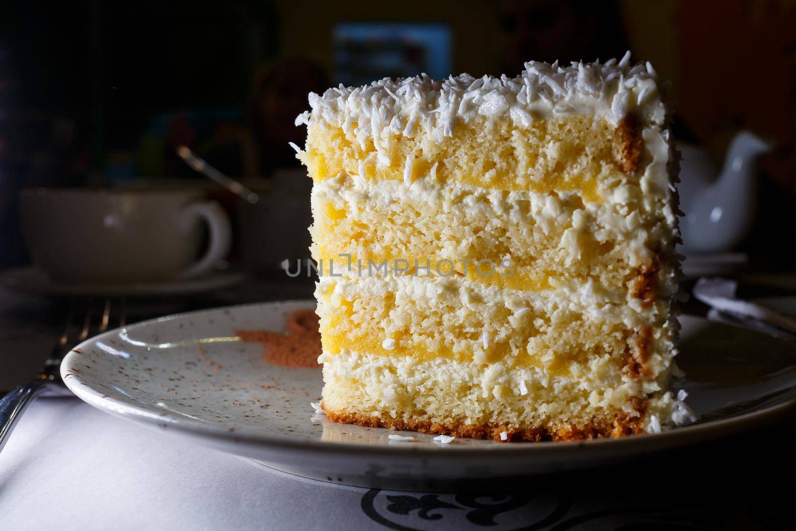 Delicious sweet piece of coconut cake with biscuit cakes
