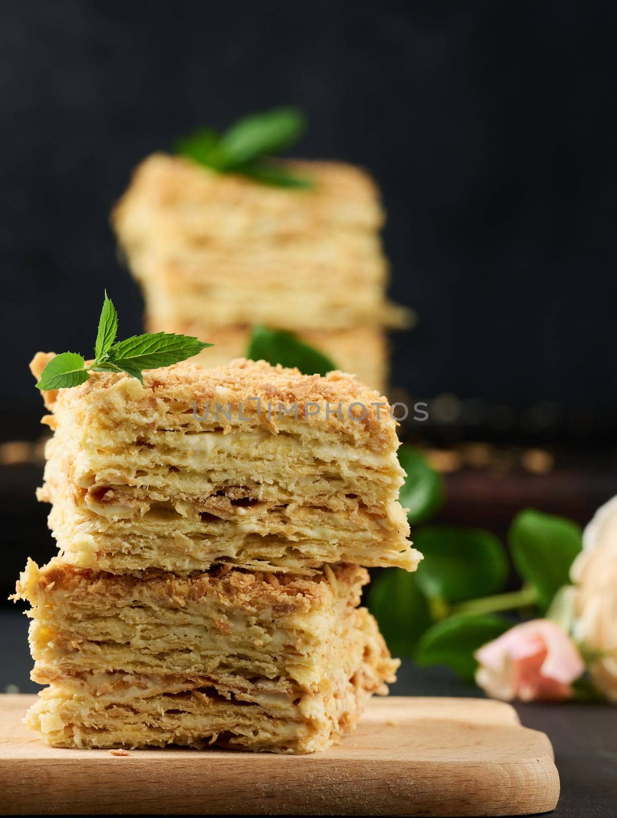 A stack of baked Napoleon pie slices with cream. Puff pastry, delicious dessert