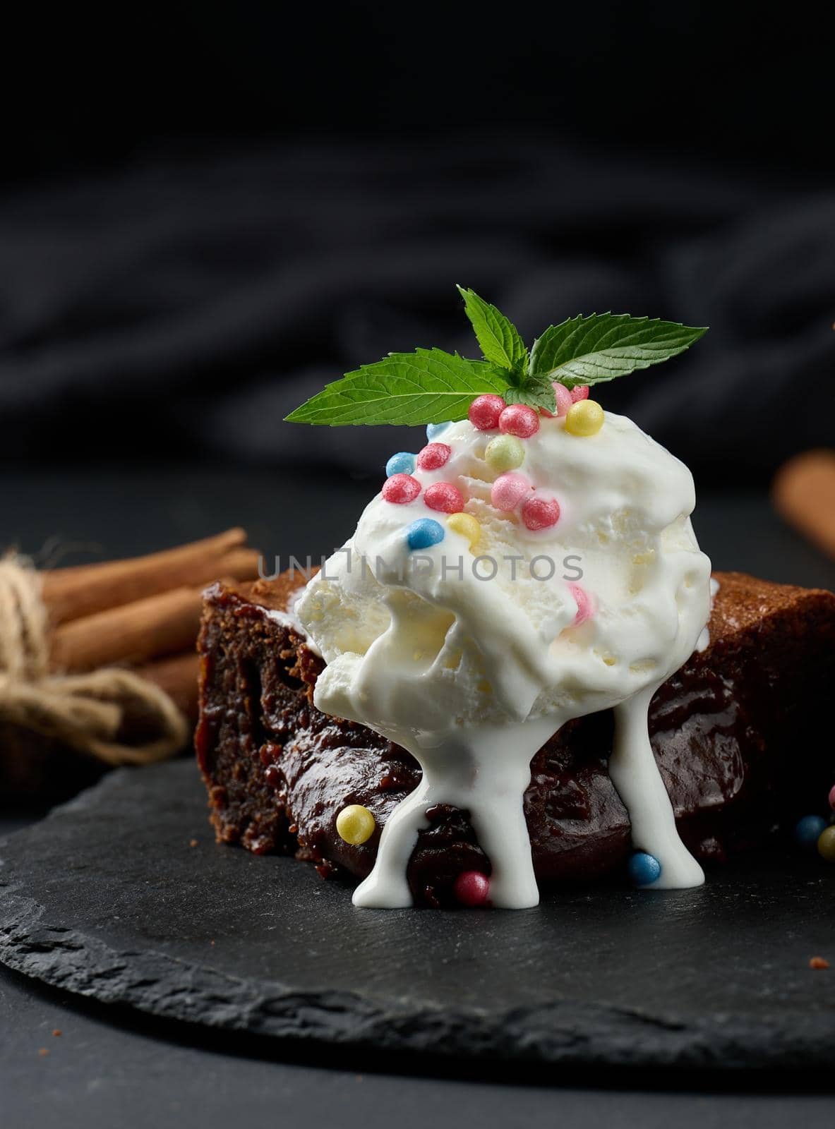 Baked pieces of chocolate brownie pie on a black table