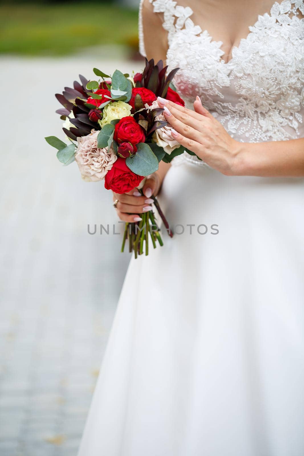 Beautiful wedding bouquet of flowers in the hands of the newlyweds