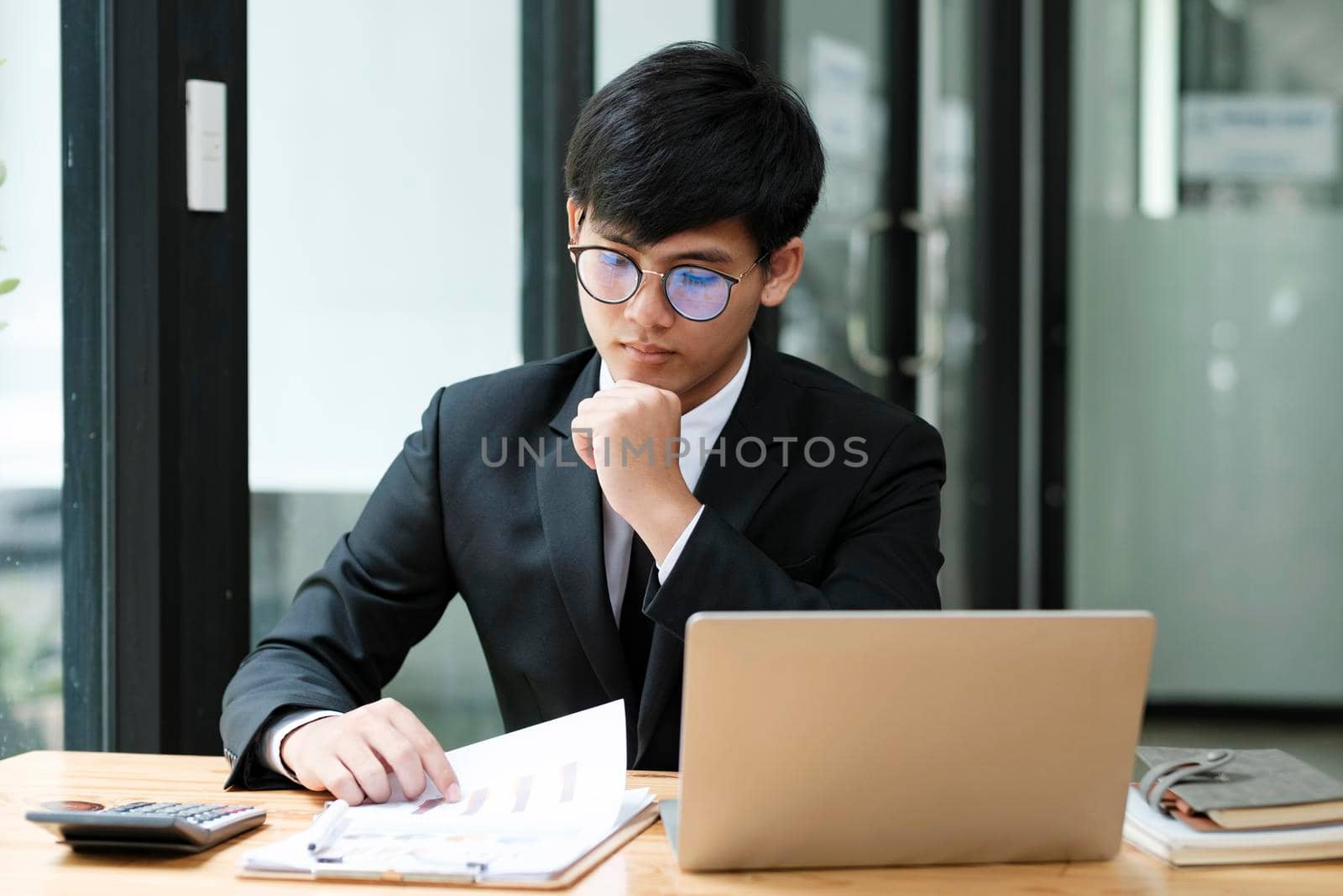 Businessman planning and analyse investment marketing data on laptop.
