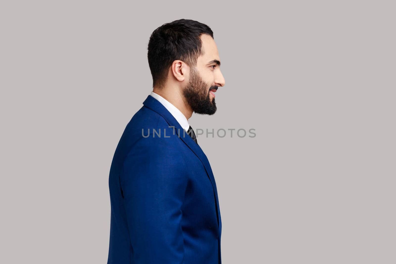 Cheerful bearded man with smile, standing and looking at camera, expressing positive emotions. by Khosro1