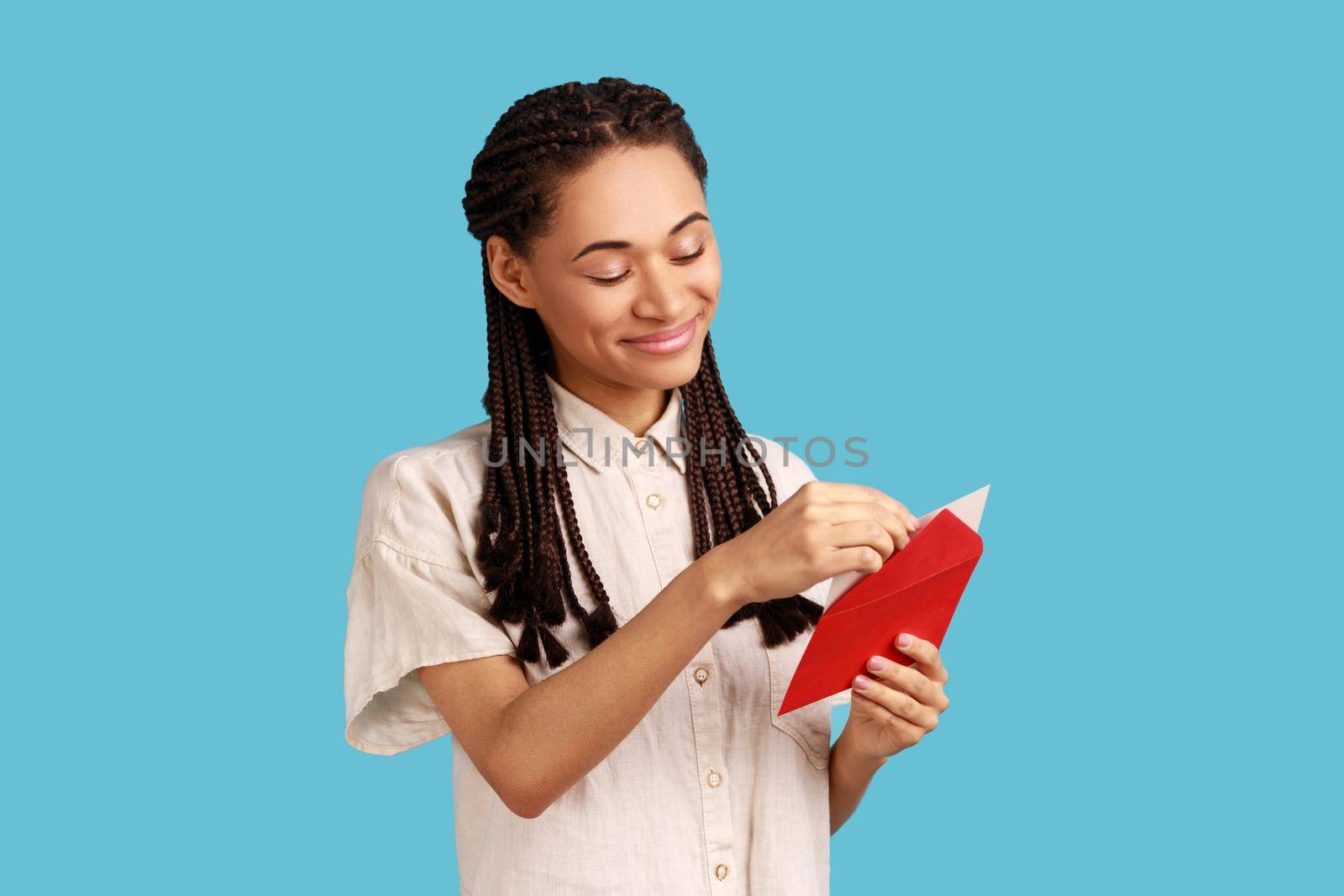 Woman standing open red envelope with congratulations, reading romantic letter. by Khosro1