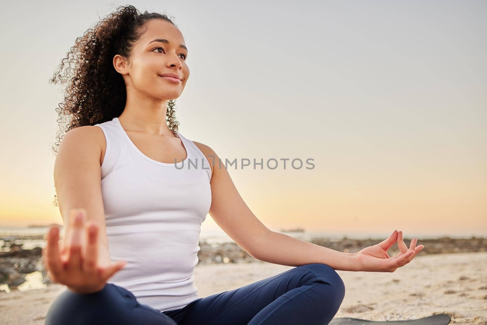 Shes on the path to inner peace. an attractive young woman meditating on the beach