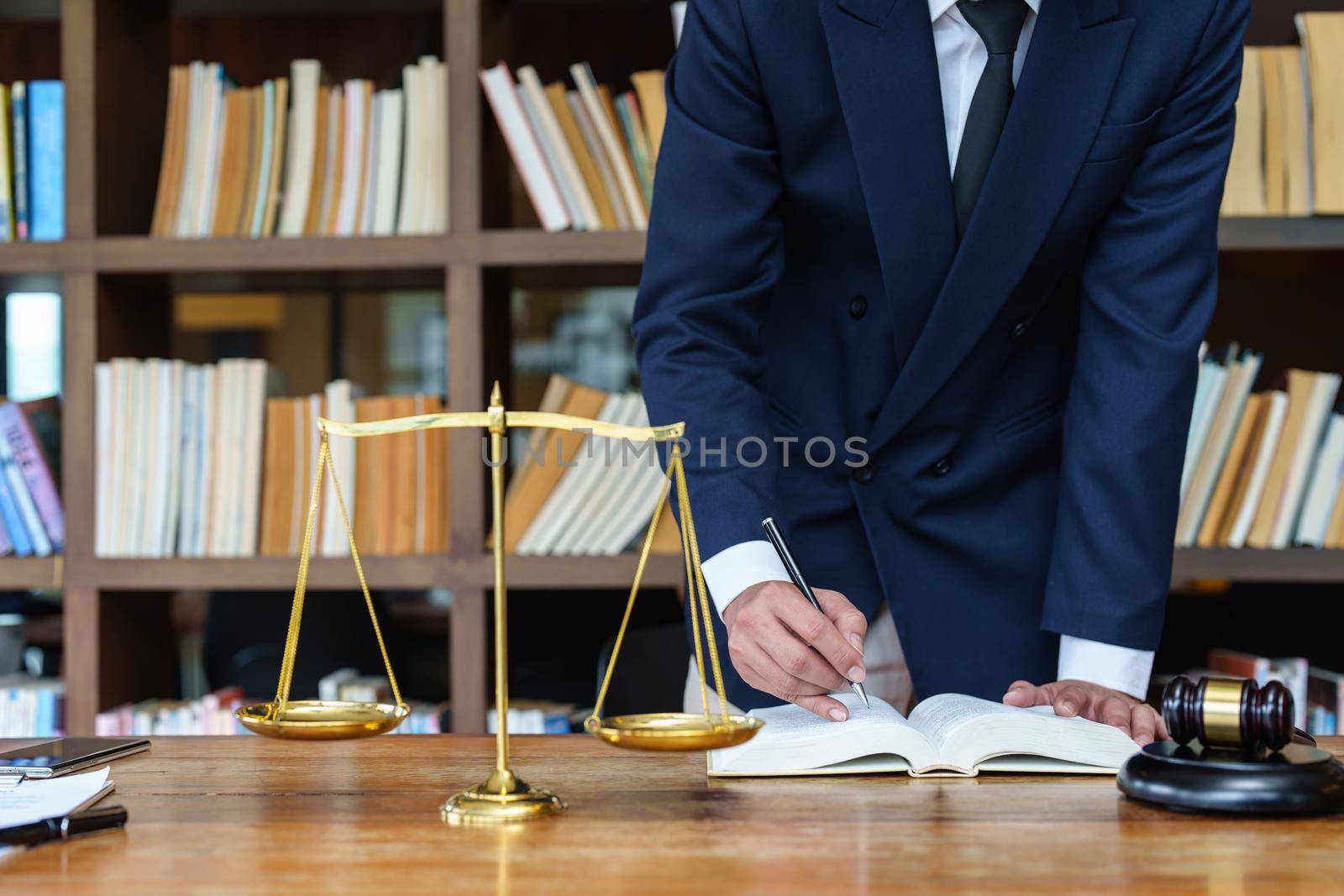 Lawyer businessman reading law book and agreement contract.