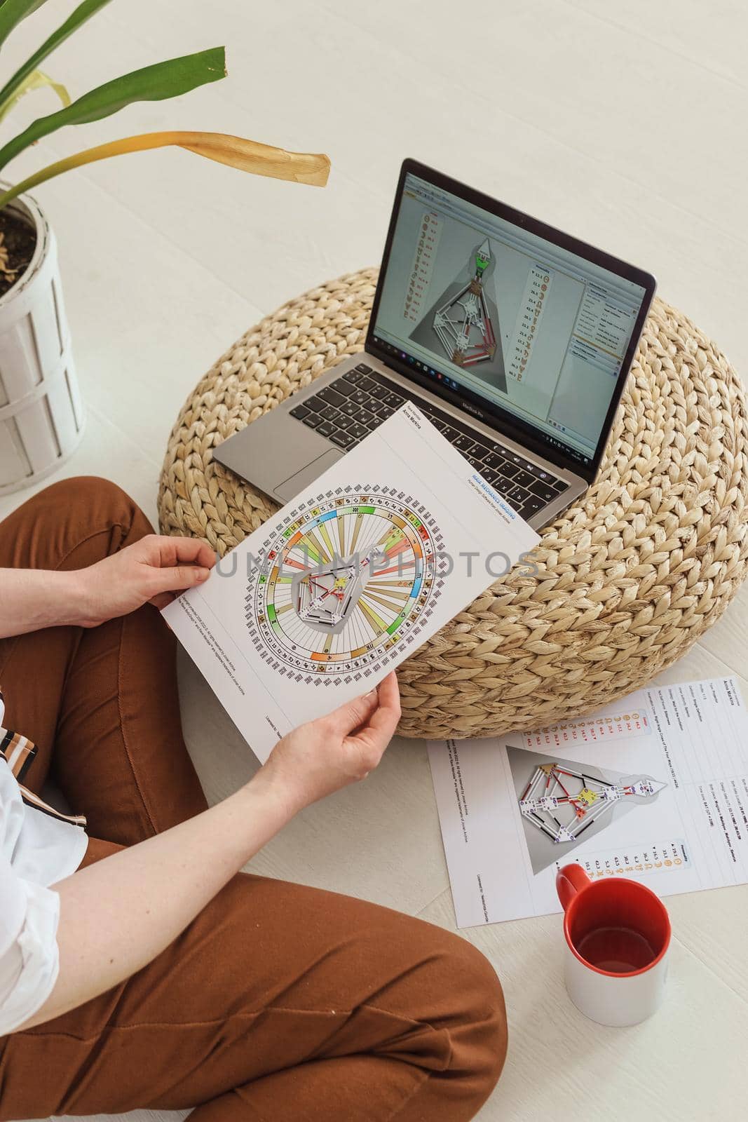 Tver, Russia-august 7, 2022. A woman with a laptop is studying human design. The concept of studying esoteric sciences. Studying rave postcards from human design.