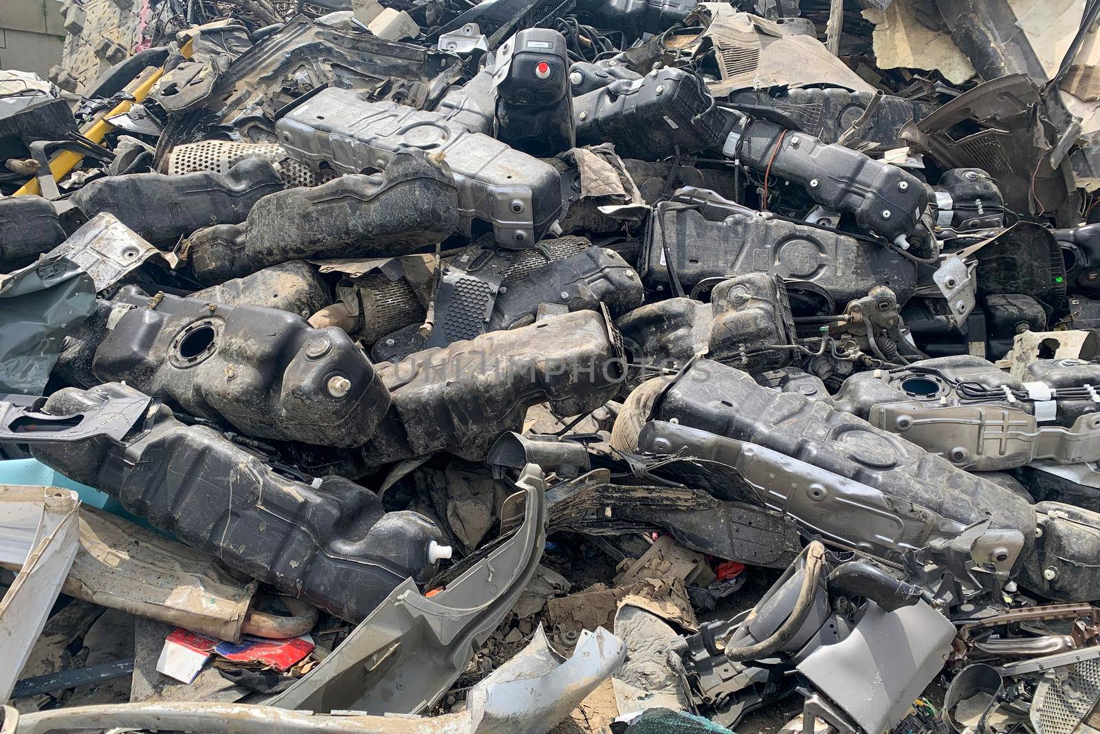A lot of fuel tanks of broken automobiles, used auto spare parts for reuse, spare parts from damaged vehicles on junk yard or car dump. by Khosro1