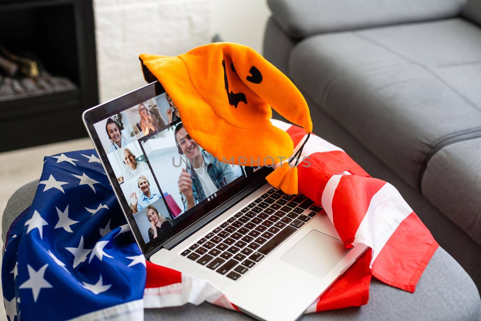 video chat on laptop with friends in decorated livingroom. Traditional autumn holiday. by Andelov13