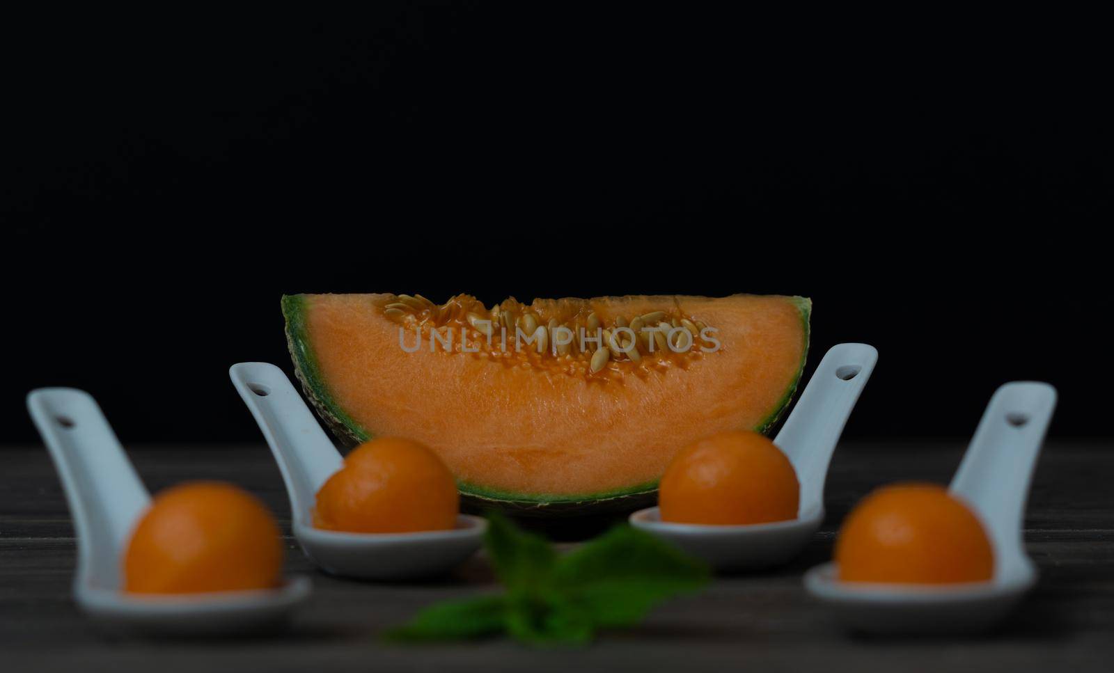 cantaloupe melon on black background dark food