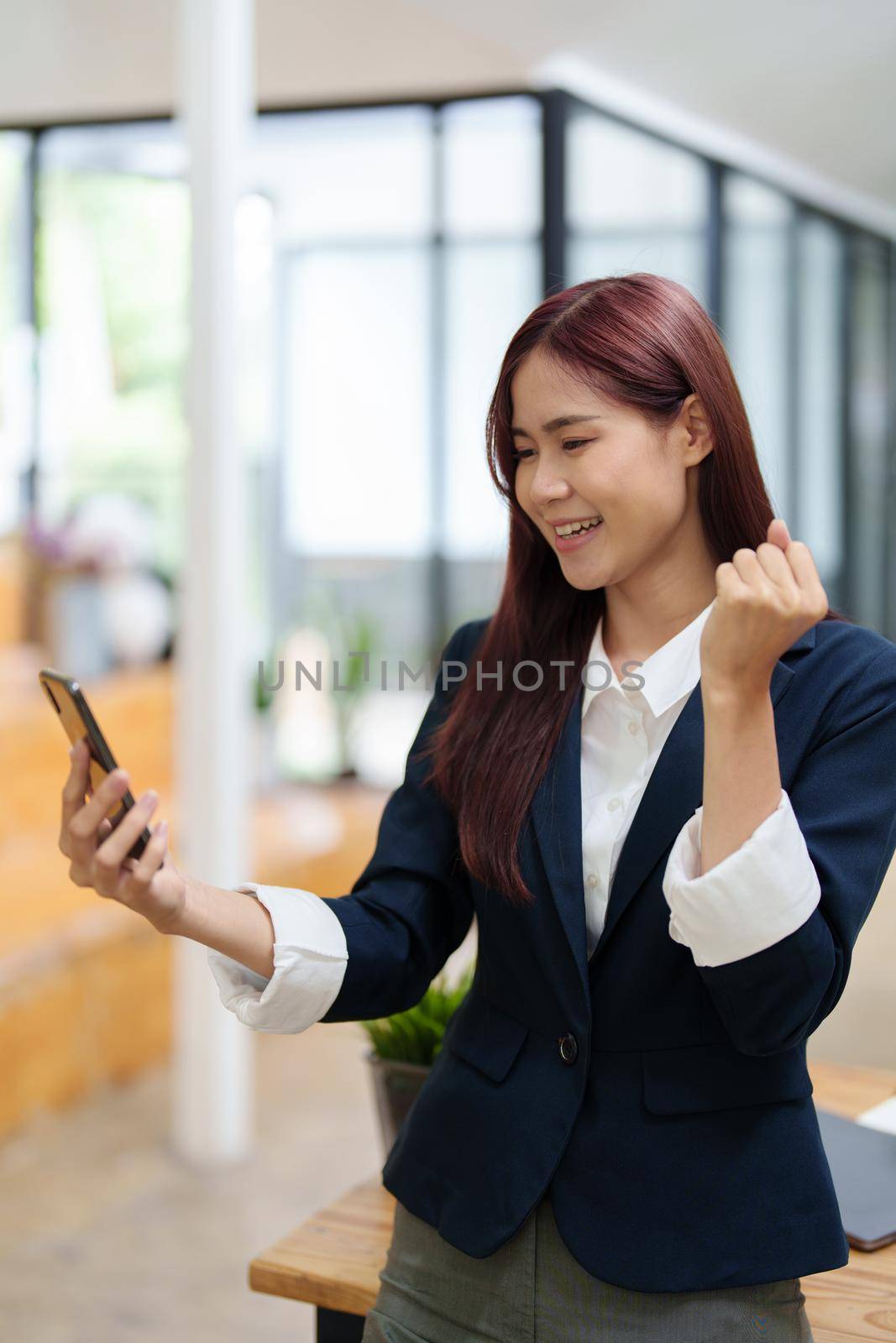 Businessmen use the smart phone to contact partners, success concept by Manastrong